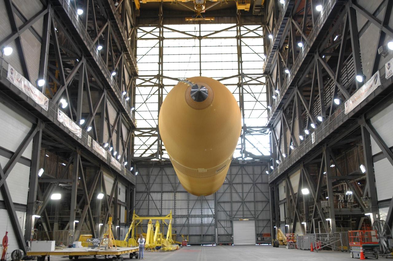 KENNEDY SPACE CENTER, FLA. -   External tank No. 118 is suspended over the transfer aisle of the Vehicle Assembly Building before being raised to vertical and into high bay 3 for mating with solid rocket boosters stacked there.  The tank is designated to fly on mission STS-115 with Atlantis.  It will fly with many major safety changes, including the removal of the protuberance air load ramps. The mission will deliver the second port truss segment, the P3/P4 Truss, to attach to the first port truss segment, the P1 Truss, as well as deploy solar array set 2A and 4A.  Launch of Space Shuttle Atlantis is scheduled for late August. Photo credit: NASA/Jim Grossmann