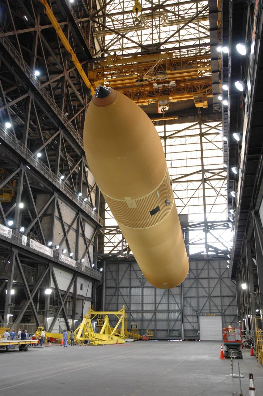 KENNEDY SPACE CENTER, FLA. -    In the Vehicle Assembly Building, a crane begins raising the head of external tank No. 118 so that the tank is suspended vertically.  The tank will be lifted into high bay 3 for mating with solid rocket boosters stacked there.  The tank is designated to fly on mission STS-115 with Atlantis.  It will fly with many major safety changes, including the removal of the protuberance air load ramps. The mission will deliver the second port truss segment, the P3/P4 Truss, to attach to the first port truss segment, the P1 Truss, as well as deploy solar array set 2A and 4A.  Launch of Space Shuttle Atlantis is scheduled for late August. Photo credit: NASA/Jim Grossmann