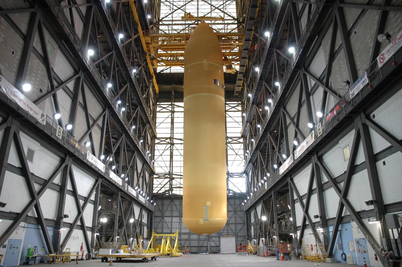 KENNEDY SPACE CENTER, FLA. -  In the Vehicle Assembly Building, external tank No. 118 is suspended vertically above the transfer aisle.  The tank will be lifted into high bay 3 for mating with solid rocket boosters stacked there.  The tank is designated to fly on mission STS-115 with Atlantis.  It will fly with many major safety changes, including the removal of the protuberance air load ramps. The mission will deliver the second port truss segment, the P3/P4 Truss, to attach to the first port truss segment, the P1 Truss, as well as deploy solar array set 2A and 4A.  Launch of Space Shuttle Atlantis is scheduled for late August. Photo credit: NASA/Jim Grossmann