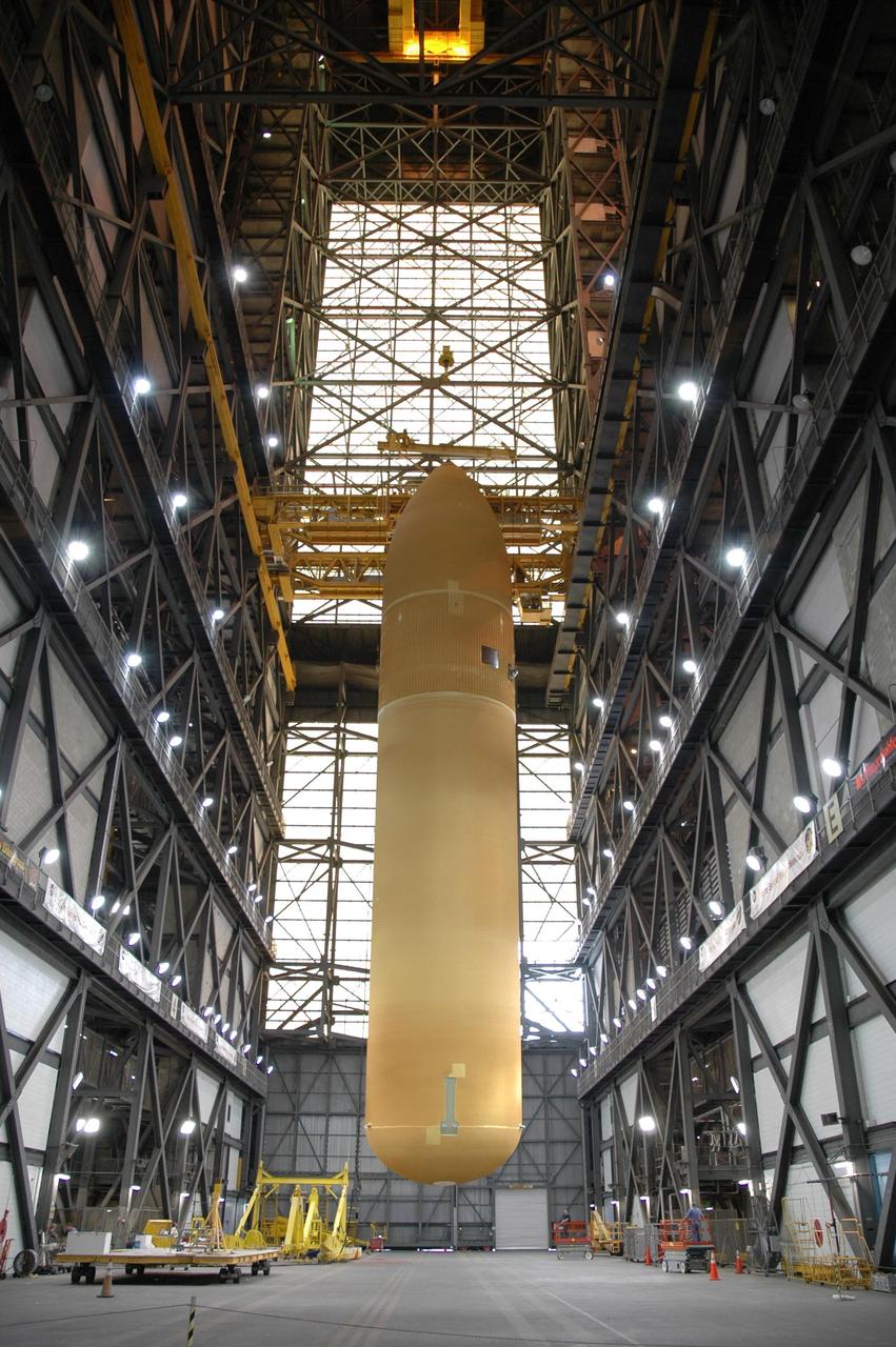 KENNEDY SPACE CENTER, FLA. -  In the Vehicle Assembly Building, external tank No. 118 is suspended vertically above the transfer aisle.  The tank will be lifted into high bay 3for mating with solid rocket boosters stacked there.  The tank is designated to fly on mission STS-115 with Atlantis.  It will fly with many major safety changes, including the removal of the protuberance air load ramps. The mission will deliver the second port truss segment, the P3/P4 Truss, to attach to the first port truss segment, the P1 Truss, as well as deploy solar array set 2A and 4A.  Launch of Space Shuttle Atlantis is scheduled for late August. Photo credit: NASA/Jim Grossmann