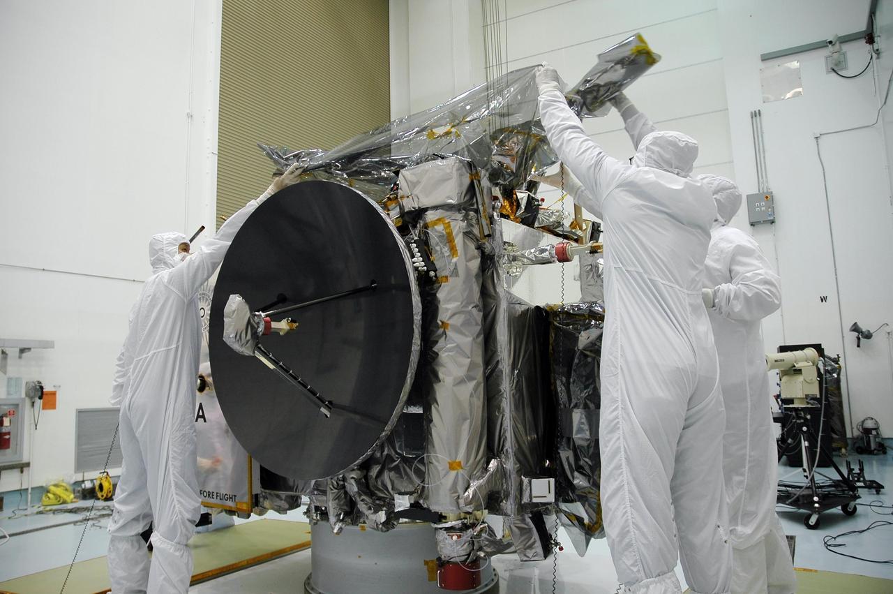 KENNEDY SPACE CENTER, FLA. - In the hazardous processing facility at Astrotech Space Operations in Titusville, Fla., technicians remove the protective cover from the top of Observatory A, one of two STEREO spacecraft. The observatory will be lifted onto a scale for weight measurements and later will be fueled. STEREO stands for Solar Terrestrial Relations Observatory. The STEREO mission is the first to take measurements of the sun and solar wind in 3-dimension. This new view will improve our understanding of space weather and its impact on the Earth. STEREO is expected to lift off aboard a Boeing Delta II rocket no earlier than Aug. 1. Photo credit: NASA/Jack Pfaller