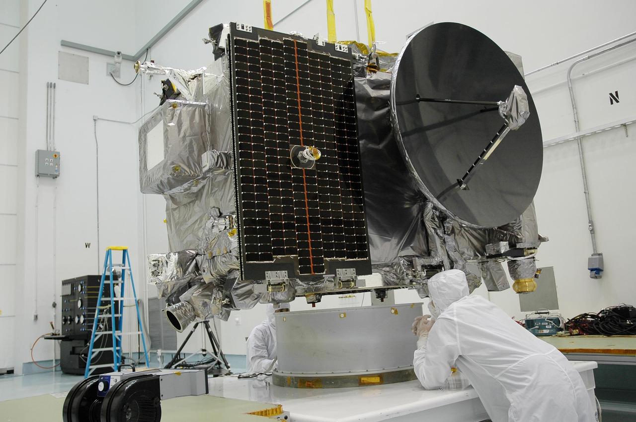 KENNEDY SPACE CENTER, FLA. - In the hazardous processing facility at Astrotech Space Operations in Titusville, Fla., technicians begin attaching an overhead crane to Observatory A of the STEREO spacecraft. The observatory will be lifted onto a scale for weight measurements and later will be fueled. STEREO stands for Solar Terrestrial Relations Observatory. The STEREO mission is the first to take measurements of the sun and solar wind in 3-dimension. This new view will improve our understanding of space weather and its impact on the Earth. STEREO is expected to lift off aboard a Boeing Delta II rocket no earlier than Aug. 1. Photo credit: NASA/Jack Pfaller