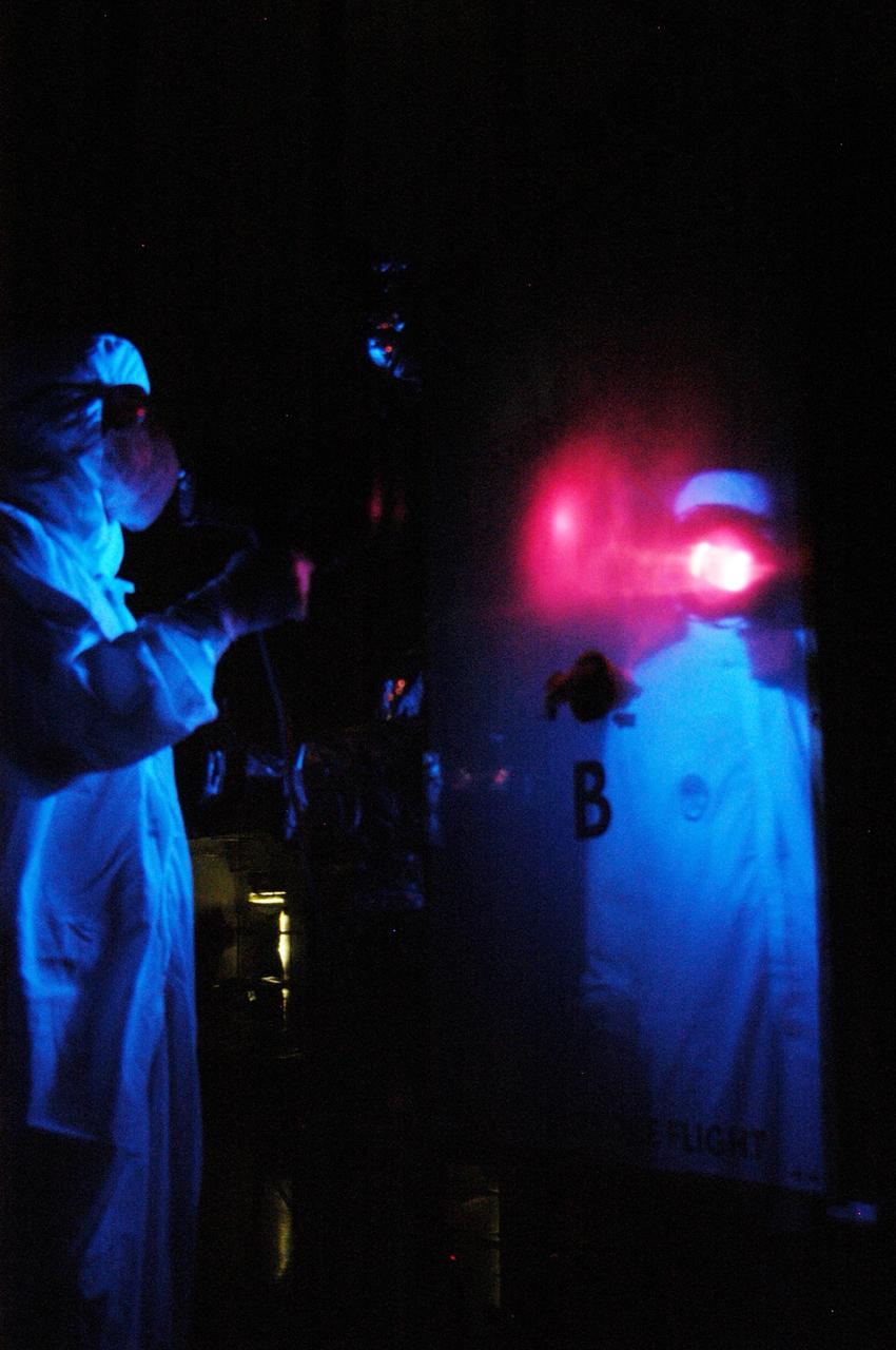 KENNEDY SPACE CENTER, FLA. -   At Astrotech Space Operations in Titusville, Fla., technicians perform black-light inspection and cleaning of Observatory B, part of the STEREO spacecraft.  The observatory will later be wrapped for transfer to the hazardous processing facility where it will be weighed and fueled.  STEREO stands for Solar Terrestrial Relations Observatory.  The STEREO mission is the first to take measurements of the sun and solar wind in 3-dimension. This new view will improve our understanding of space weather and its impact on the Earth.  STEREO is expected to lift off aboard a Boeing Delta II rocket no earlier than Aug. 1.  Photo credit: NASA/George Shelton