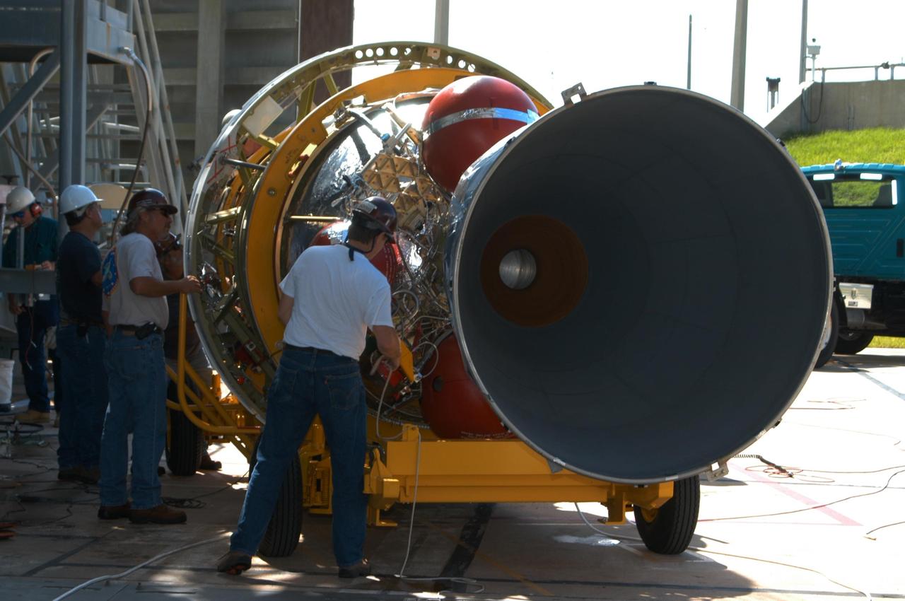 KENNEDY SPACE CENTER, FLA. - At Launch Pad 17-B on Cape Canaveral Air Force Station, workers prepare the Boeing Delta II second stage for the STEREO launch to be lifted off the transporter. The second stage then will be lifted into the mobile service tower and mated with first stage already in place. STEREO stands for Solar Terrestrial Relations Observatory and comprises two spacecraft. The STEREO mission is the first to take measurements of the sun and solar wind in 3-dimension. This new view will improve our understanding of space weather and its impact on the Earth. STEREO is expected to lift off in August 2006. Photo credit: NASA/George Shelton