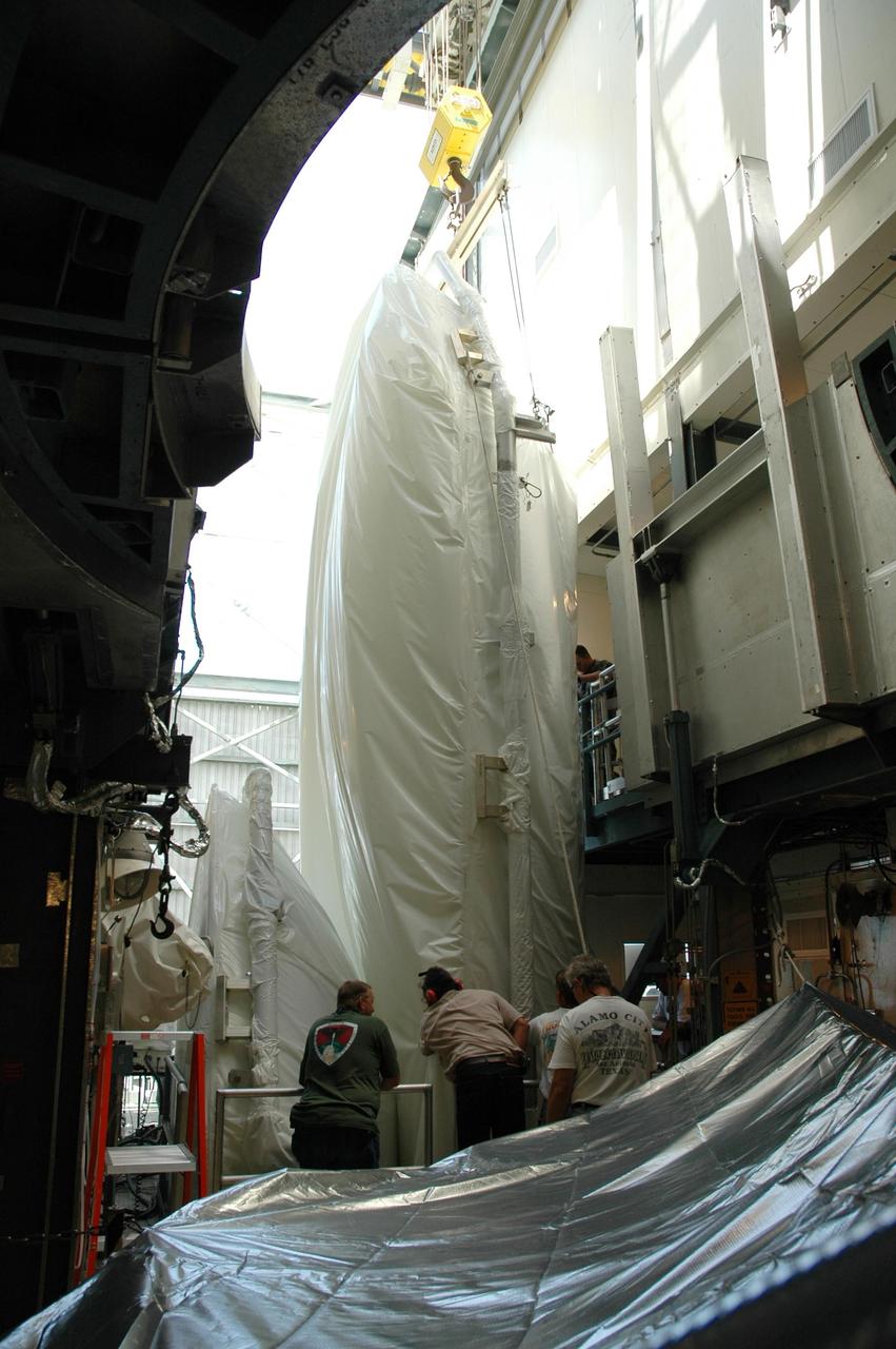 KENNEDY SPACE CENTER, FLA. - Inside the mobile service tower on Launch Pad 17-B at Cape Canaveral Air Force Station in Florida, the shrouded second half of the payload fairing (background) for the STEREO spacecraft is moved beside the first half. Both halves will later be installed around the spacecraft for protection during launch. The fairing is a molded structure that fits flush with the outside surface of the Delta II upper stage booster and forms an aerodynamically smooth nose cone, protecting the spacecraft during launch and ascent. STEREO, which stands for Solar Terrestrial Relations Observatory, comprises two spacecraft that will be launched as one. The STEREO mission is the first to take measurements of the sun and solar wind in 3-dimension. This new view will improve our understanding of space weather and its impact on the Earth. STEREO is expected to lift off aboard a Boeing Delta II rocket in August 2006. Photo credit: NASA/Jim Grossmann