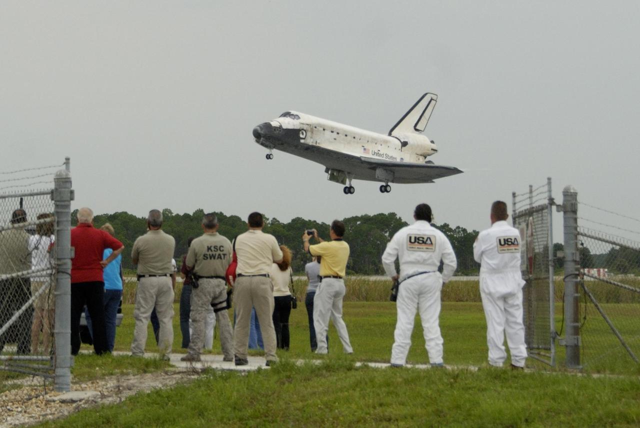 KENNEDY SPACE CENTER, FLA. - The orbiter Discovery, with Commander Steven Lindsey at the helm, approaches Runway 15 at NASA's Shuttle Landing Facility for landing after completing mission STS-121 to the International Space Station. Discovery traveled 5.3 million miles, landing on orbit 202. Mission elapsed time was 12 days, 18 hours, 37 minutes and 54 seconds. Main gear touchdown occurred on time at 9:14:43 EDT. Wheel stop was at 9:15:49 EDT. The rest of the crew aboard are Pilot Mark Kelly and Mission Specialists Piers Sellers, Michael Fossum, Lisa Nowak and Stephanie Wilson. Mission Specialist Thomas Reiter, who launched with the crew on July 4, remained on the station to join the Expedition 13 crew there. The landing is the 62nd at Kennedy Space Center and the 32nd for Discovery. Discovery's landing was as exhilarating as its launch, the first to take place on America's Independence Day. During the mission, the STS-121 crew tested new equipment and procedures to improve shuttle safety, and delivered supplies and made repairs to the International Space Station. Photo courtesy of Nikon/Scott Andrews
