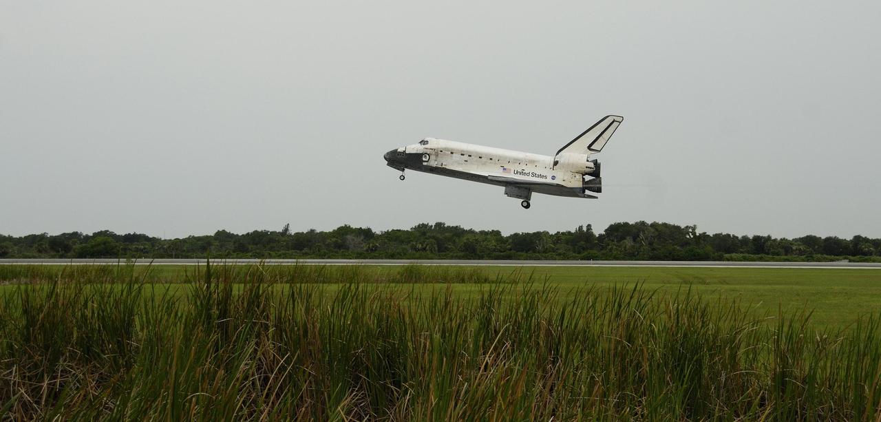KENNEDY SPACE CENTER, FLA. - The orbiter Discovery, with Commander Steven Lindsey at the helm, approaches Runway 15 at NASA's Shuttle Landing Facility for landing after completing mission STS-121 to the International Space Station. Discovery traveled 5.3 million miles, landing on orbit 202. Mission elapsed time was 12 days, 18 hours, 37 minutes and 54 seconds. Main gear touchdown occurred on time at 9:14:43 EDT. Wheel stop was at 9:15:49 EDT. The rest of the crew aboard are Pilot Mark Kelly and Mission Specialists Piers Sellers, Michael Fossum, Lisa Nowak and Stephanie Wilson. Mission Specialist Thomas Reiter, who launched with the crew on July 4, remained on the station to join the Expedition 13 crew there. The landing is the 62nd at Kennedy Space Center and the 32nd for Discovery. Discovery's landing was as exhilarating as its launch, the first to take place on America's Independence Day. During the mission, the STS-121 crew tested new equipment and procedures to improve shuttle safety, and delivered supplies and made repairs to the International Space Station. Photo courtesy of Nikon/Scott Andrews