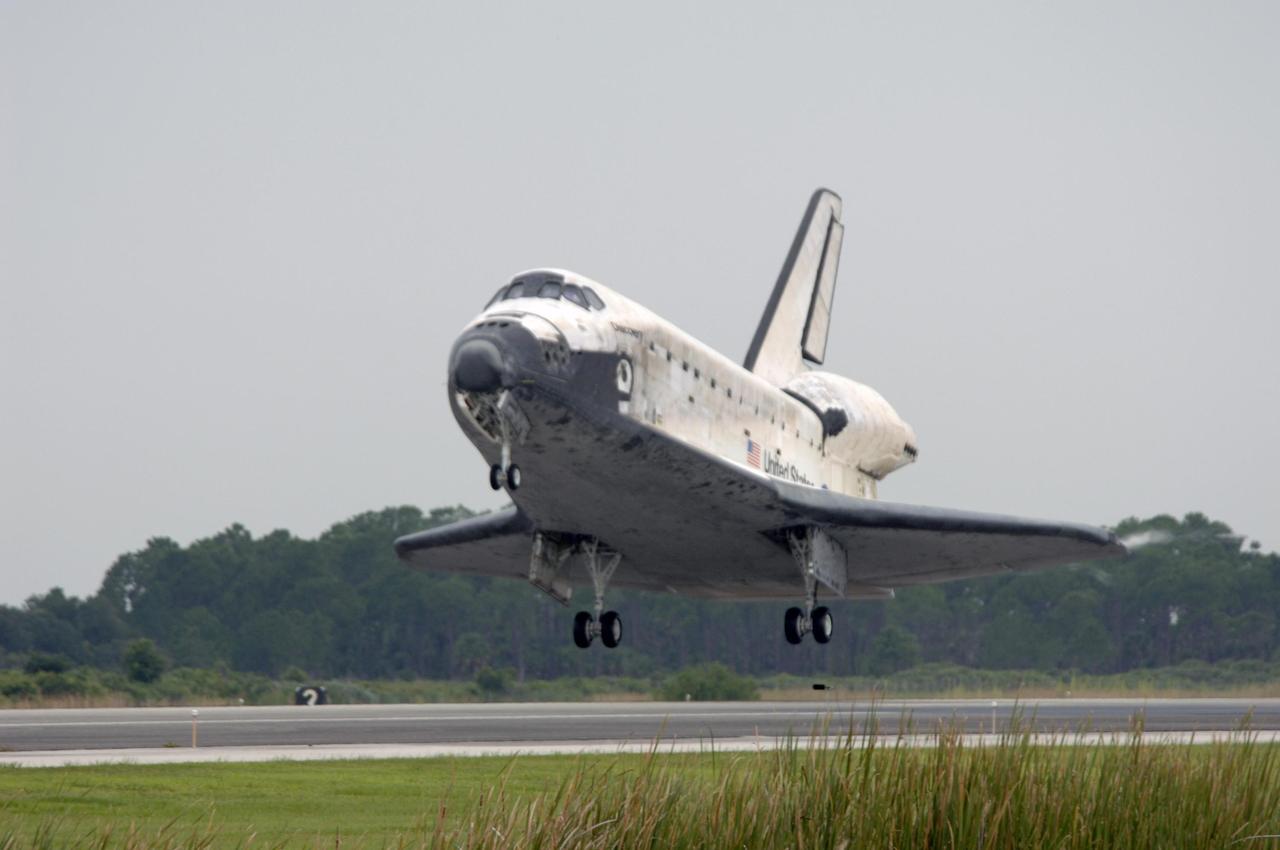 KENNEDY SPACE CENTER, FLA. - The orbiter Discovery drops toward Runway 15 at NASA's Shuttle Landing Facility for landing after completing mission STS-121 to the International Space Station. Discovery traveled 5.3 million miles, landing on orbit 202. Mission elapsed time was 12 days, 18 hours, 37 minutes and 54 seconds. Main gear touchdown occurred on time at 9:14:43 EDT. Wheel stop was at 9:15:49 EDT. The returning crew members aboard are Commander Steven Lindsey, Pilot Mark Kelly and Mission Specialists Piers Sellers, Michael Fossum, Lisa Nowak and Stephanie Wilson. Mission Specialist Thomas Reiter, who launched with the crew on July 4, remained on the station to join the Expedition 13 crew there. The landing is the 62nd at Kennedy Space Center and the 32nd for Discovery. Discovery's landing was as exhilarating as its launch, the first to take place on America's Independence Day. During the mission, the STS-121 crew tested new equipment and procedures to improve shuttle safety, and delivered supplies and made repairs to the International Space Station. Photo credit: NASA/Tim Powers