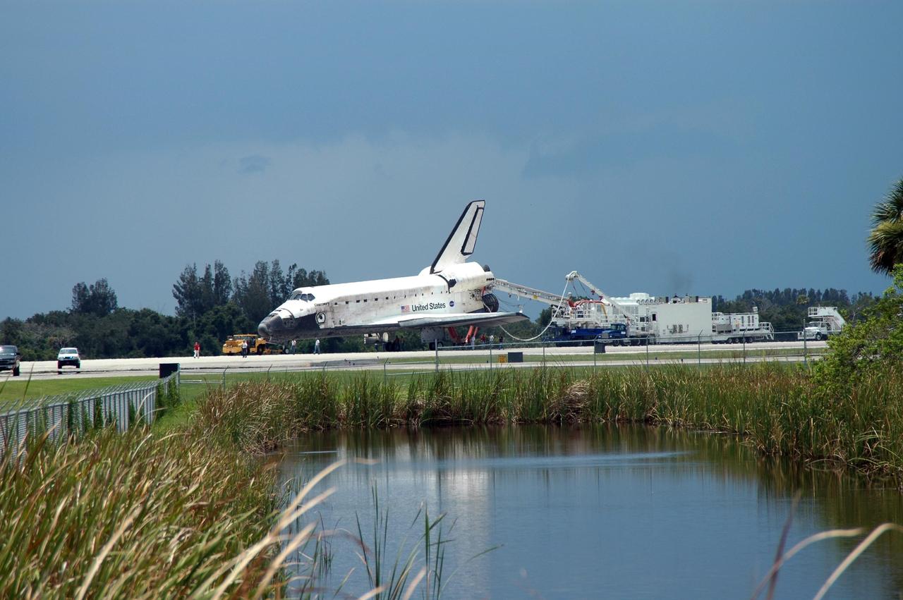 KENNEDY SPACE CENTER, FLA. -  On NASA's Shuttle Landing Facility (SLF) at Kennedy Space Center, the orbiter Discovery is prepared for transport to the Orbiter Processing Facility.  Discovery landed at the SLF at 9:14 a.m. EDT, completing mission STS-121. Discovery traveled  5.3 million miles, landing on orbit 202.  Mission elapsed time was 12 days, 18 hours, 37 minutes and 54 seconds.  Main gear touchdown occurred on time at 9:14:43 EDT.  Wheel stop was at 9:15:49 EDT. During the mission, the STS-121 crew tested new equipment and procedures to improve shuttle safety, and delivered supplies and made repairs to the International Space Station.  Photo credit: NASA/Jim Grossmann