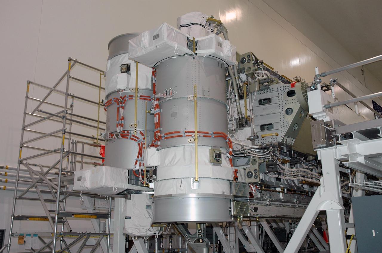 KENNEDY SPACE CENTER, FLA.  -    The next element to be added to the International Space Station, the Port 3/4 truss segment is being moved to a payload canister for installation in the orbiter Atlantis.  The cylinders shown are the mast canisters for the solar arrays.  The truss is slated for launch on mission STS-115 no earlier than Aug. 28. The truss is the next major addition to the 11-segment integrated truss structure that will eventually span more than 300 feet on the station. The P3/P4 truss, with its two large solar arrays, will provide one-fourth of the total power-generation capability of the completed station.  The P3/P4 truss is expected to be loaded into Atlantis's cargo bay around the beginning of August.  Photo credit: NASA/Troy Cryder