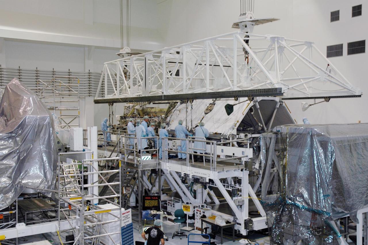 KENNEDY SPACE CENTER, FLA.  -   In the Space Station Processing Facility, an overhead crane is ready to lift the Port 3/4 truss segment and move it to a payload canister for installation in the orbiter Atlantis.  The truss is slated for launch on mission STS-115 no earlier than Aug. 28. The truss is the next major addition to the 11-segment integrated truss structure that will eventually span more than 300 feet on the station. The P3/P4 truss, with its two large solar arrays, will provide one-fourth of the total power-generation capability of the completed station.  The P3/P4 truss is expected to be loaded into Atlantis's cargo bay around the beginning of August.  Photo credit: NASA/Troy Cryder