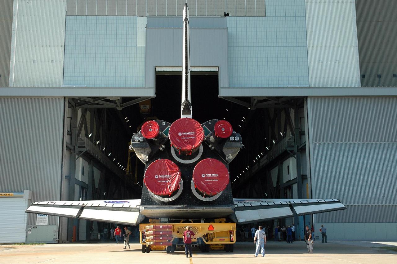 KENNEDY SPACE CENTER, FLA. - Atlantis glides into the open doors of the Vehicle Assembly Building into the transfer aisle, concluding its rollover from the Orbiter Processing Facility. In the VAB, the orbiter will be lifted into high bay 3 for mating to the external fuel tank and solid rocket boosters. Atlantis' launch window begins Aug. 28. During its 11-day mission to the International Space Station, the STS-115 crew of six astronauts will install the Port 3/4 truss segment with its two large solar arrays. Photo credit: NASA/Charisse Nahser