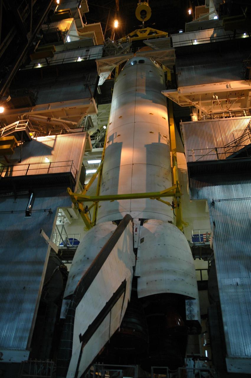 KENNEDY SPACE CENTER, FLA.  - In the Vehicle Assembly Building, Atlantis is lowered into high bay 3 for mating with the external tank and solid rocket boosters already installed on the mobile launcher platform. After the stacking, Atlantis will undergo a shuttle interface test and other prelaunch processing.  Atlantis' launch window begins Aug. 28. During its 11-day mission to the International Space Station, the STS-115 crew of six astronauts will continue construction of the station and install their cargo, the Port 3/4 truss segment with its two large solar arrays.  Photo credit: NASA/Troy Cryder