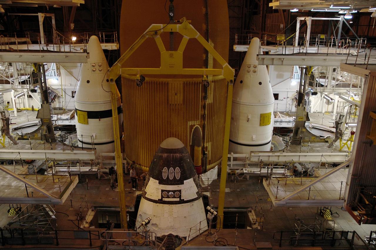 KENNEDY SPACE CENTER, FLA.  - In high bay 3 of the Vehicle Assembly Building, the nose of the orbiter Atlantis is dwarfed by the external tank behind it and the twin solid rocket boosters.  The orbiter is being mated with the tank and boosters, already installed on the mobile launcher platform below.  After the stacking, Atlantis will undergo a shuttle interface test and other prelaunch processing.  Atlantis' launch window begins Aug. 28. During its 11-day mission to the International Space Station, the STS-115 crew of six astronauts will continue construction of the station and install their cargo, the Port 3/4 truss segment with its two large solar arrays.  Photo credit: NASA/Troy Cryder