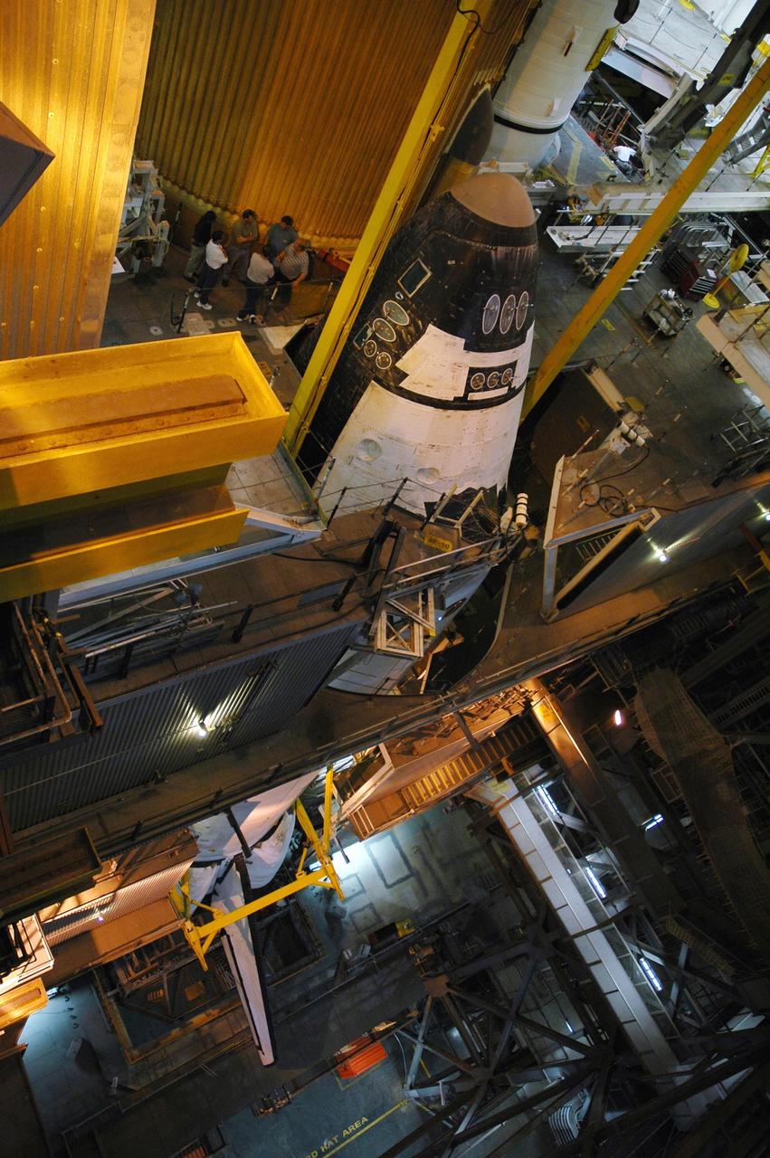 KENNEDY SPACE CENTER, FLA.  - In high bay 3 of the Vehicle Assembly Building, the orbiter Atlantis has been lowered onto the mobile launcher platform below for mating with the external tank and solid rocket boosters already in place. After the stacking, Atlantis will undergo a shuttle interface test and other prelaunch processing.  Atlantis' launch window begins Aug. 28. During its 11-day mission to the International Space Station, the STS-115 crew of six astronauts will continue construction of the station and install their cargo, the Port 3/4 truss segment with its two large solar arrays.  Photo credit: NASA/Troy Cryder