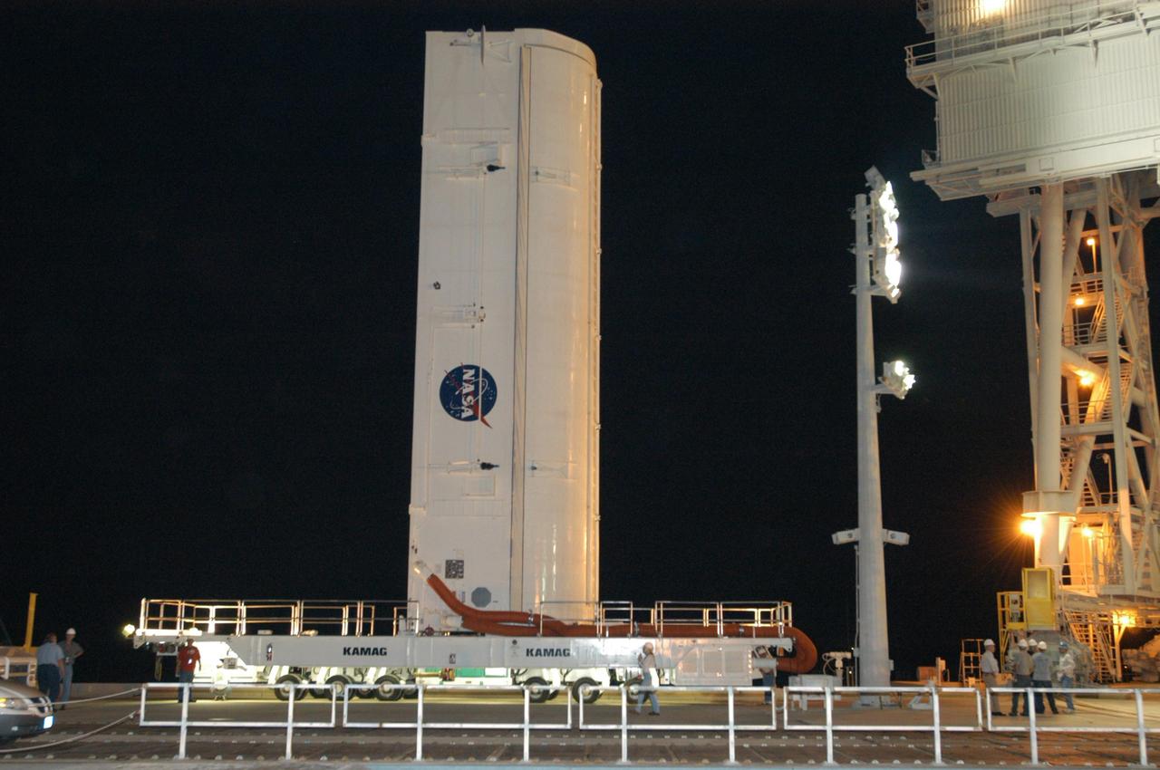 KENNEDY SPACE CENTER, FLA.  - After a several-hour trip from the Canister Rotation Facility, the payload canister arrives on Launch Pad 39B.  Inside the canister is the payload for Atlantis and mission STS-115, the Port 3/4 truss segment with two large solar arrays.  The canister will be positioned alongside the rotating service structure and beneath the payload changeout room (PCR) for transfer of the truss into the PCR.   The payload changeout room provides an environmentally clean or "white room" condition in which to receive a payload transferred from a protective payload canister. After the shuttle arrives at the pad, the rotating service structure will close around it and the payload will then be transferred into Atlantis' payload bay.  Atlantis' launch window begins Aug. 28. During its 11-day mission to the International Space Station, the STS-115 crew of six astronauts will install  the truss, a 17-ton segment of the space station's truss backbone.  Photo credit: NASA/George Shelton