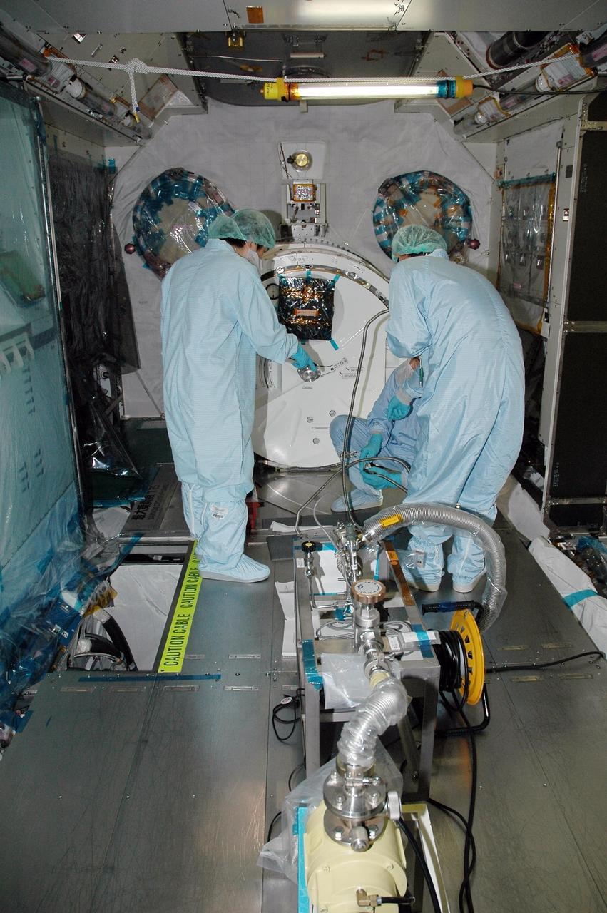 KENNEDY SPACE CENTER, FLA. - In the Space Station Processing Facility, Japan Aerospace Exploration Agency (JAXA) technicians install piping insulation on the Japanese Experiment Module (JEM).  The JEM, developed by JAXA for use on the International Space Station, is named Kibo -- which means "hope" in Japanese -- and will enhance the unique research capabilities of the orbiting complex by providing an additional environment for astronauts to conduct science experiments.  Research conducted in Kibo will focus on space medicine, biology, Earth observations, material production, biotechnology and communications. Photo credit: NASA/Amanda Diller