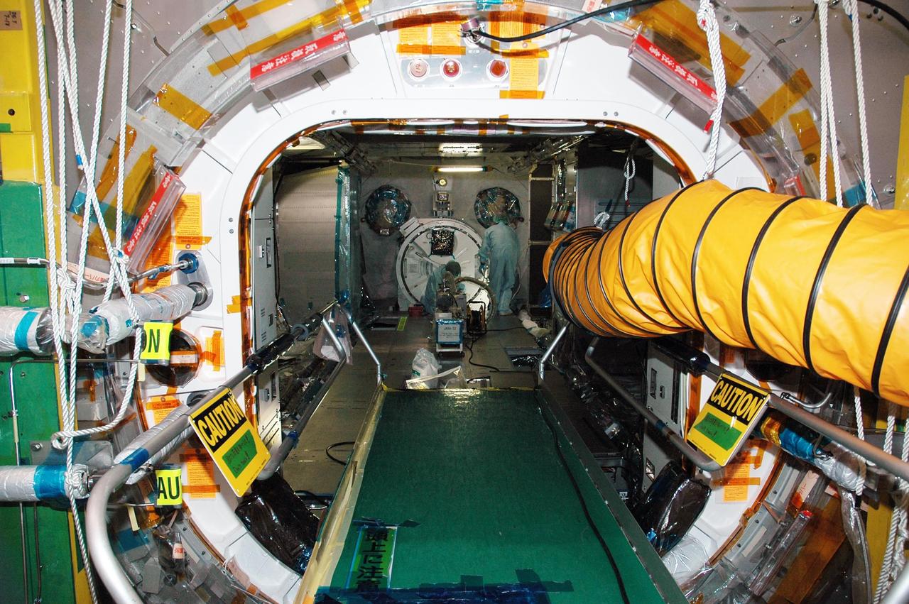 KENNEDY SPACE CENTER, FLA. - In the Space Station Processing Facility, Japan Aerospace Exploration Agency (JAXA) technicians install piping insulation on the Japanese Experiment Module (JEM).  The JEM, developed by JAXA for use on the International Space Station, is named Kibo -- which means "hope" in Japanese -- and will enhance the unique research capabilities of the orbiting complex by providing an additional environment for astronauts to conduct science experiments.  Research conducted in Kibo will focus on space medicine, biology, Earth observations, material production, biotechnology and communications. Photo credit: NASA/Amanda Diller