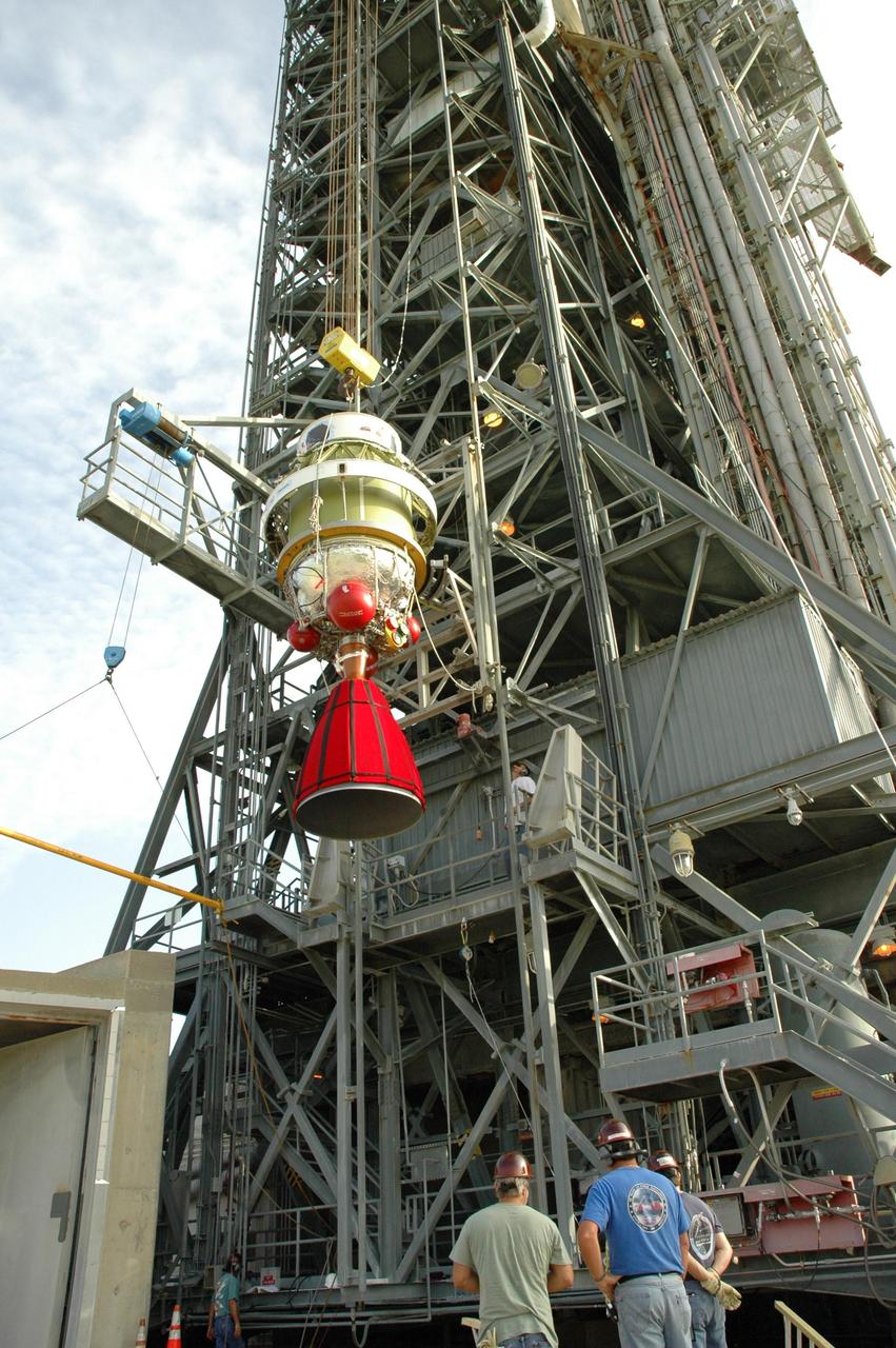 KENNEDY SPACE CENTER, FLA. - On Launch Pad 17-B at Cape Canaveral Air Force Station in Florida, the second stage segment of the Delta II rocket is lowered from the mobile service tower. At the Boeing plant in Alabama, a leak was observed in the second-stage oxidizer tank for another Delta II that had been scheduled to launch in November; therefore, all identical tanks scheduled for launch in the near future are being checked. The second stage for the Delta II that will launch STEREO cannot be effectively tested while atop the first stage at Pad 17-B. STEREO stands for Solar Terrestrial Relations Observatory and comprises two spacecraft. The STEREO mission is the first to take measurements of the sun and solar wind in 3-dimension. This new view will improve our understanding of space weather and its impact on the Earth. STEREO is expected to lift off in late August 2006. Photo credit: NASA/Jim Grossmann