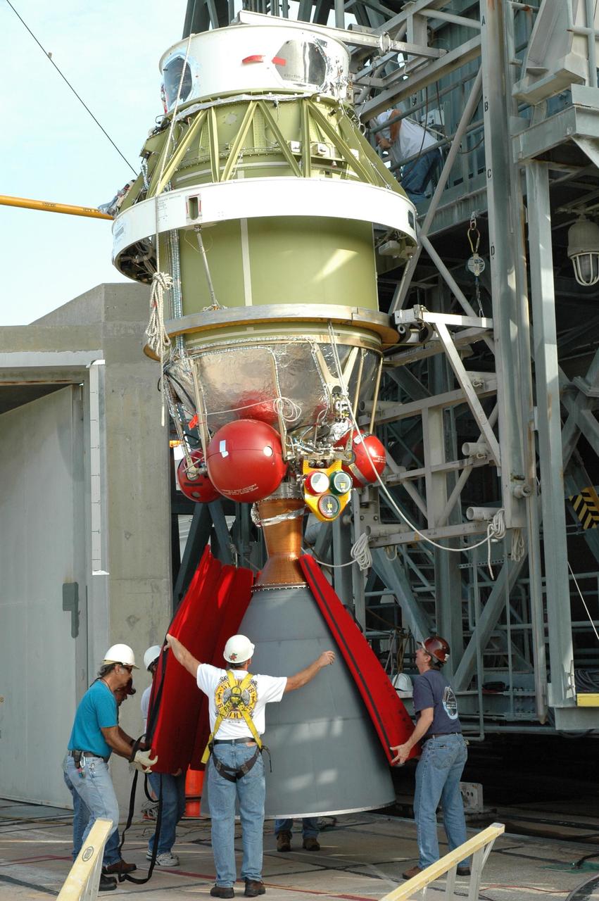 KENNEDY SPACE CENTER, FLA. -  On Launch Pad 17-B at Cape Canaveral Air Force Station in Florida, workers remove the protective covers from the engine nozzle on the second stage segment removed from the Delta II rocket.   At the Boeing plant in Alabama, a leak was observed in the second-stage oxidizer tank for another Delta II that had been scheduled to launch in November; therefore, all identical tanks scheduled for launch in the near future are being checked.  The second stage for the Delta II that will launch STEREO cannot be effectively tested while atop the first stage at Pad 17-B. STEREO stands for Solar Terrestrial Relations Observatory and comprises two spacecraft.  The STEREO mission is the first to take measurements of the sun and solar wind in 3-dimension. This new view will improve our understanding of space weather and its impact on the Earth.  STEREO is expected to lift off in late August 2006.  Photo credit: NASA/Jim Grossmann