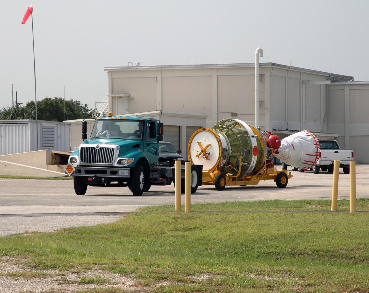 KENNEDY SPACE CENTER, FLA. - On Launch Pad 17-B at Cape Canaveral Air Force Station in Florida, the second stage segment of a Delta II rocket is being transported to the High-Pressure Test Facility for leak testing. The segment was destacked from the Delta II rocket in the mobile service tower. At the Boeing plant in Alabama, a leak was observed in the second-stage oxidizer tank for another Delta II that had been scheduled to launch in November; therefore, all identical tanks scheduled for launch in the near future are being checked. The second stage for the Delta II that will launch STEREO cannot be effectively tested while atop the first stage at Pad 17-B. STEREO stands for Solar Terrestrial Relations Observatory and comprises two spacecraft. The STEREO mission is the first to take measurements of the sun and solar wind in 3-dimension. This new view will improve our understanding of space weather and its impact on the Earth. STEREO is expected to lift off in late August 2006. Photo credit: NASA/Jim Grossmann