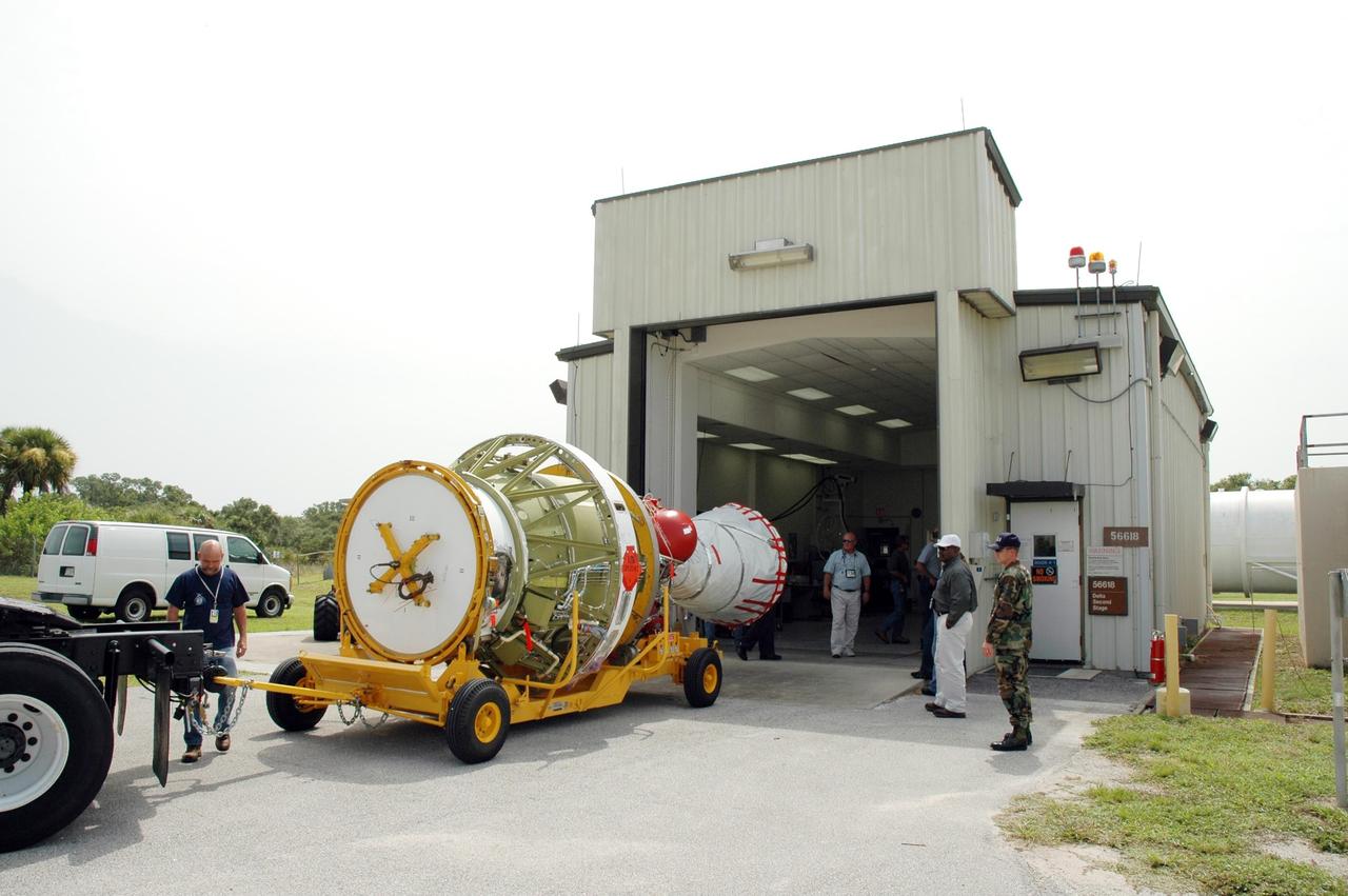 KENNEDY SPACE CENTER, FLA. - On Launch Pad 17-B at Cape Canaveral Air Force Station in Florida, the transporter carrying the second stage segment of a Delta II rocket arrives at the High-Pressure Test Facility for leak testing. The segment was destacked from the Delta II rocket in the mobile service tower. At the Boeing plant in Alabama, a leak was observed in the second-stage oxidizer tank for another Delta II that had been scheduled to launch in November; therefore, all identical tanks scheduled for launch in the near future are being checked. The second stage for the Delta II that will launch STEREO cannot be effectively tested while atop the first stage at Pad 17-B. STEREO stands for Solar Terrestrial Relations Observatory and comprises two spacecraft. The STEREO mission is the first to take measurements of the sun and solar wind in 3-dimension. This new view will improve our understanding of space weather and its impact on the Earth. STEREO is expected to lift off in late August 2006. Photo credit: NASA/Jim Grossmann