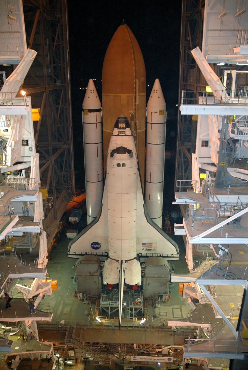KENNEDY SPACE CENTER, FLA. -  Sitting on top of the mobile launcher platform, Space Shuttle Atlantis begins rolling out of the Vehicle Assembly Building to Launch Pad 39B via the crawler-transporter underneath.   First motion was at 1:05 a.m.  The slow speed of the crawler results in a 6-hour trek to the pad approximately 4 miles away.  Atlantis' launch window begins Aug. 27 for an 11-day mission to the International Space Station. The STS-115 crew of six astronauts will continue construction of the station and install their cargo, the Port 3/4 truss segment with its two large solar arrays.   Photo credit: NASA/Troy Cryder