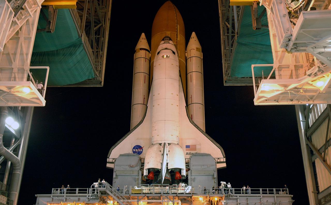 KENNEDY SPACE CENTER, FLA. -  Sitting on top of the mobile launcher platform, Space Shuttle Atlantis rolls out of the Vehicle Assembly Building to Launch Pad 39B via the crawler-transporter underneath.   First motion was at 1:05 a.m.  The slow speed of the crawler results in a 6-hour trek to the pad approximately 4 miles away.  Atlantis' launch window begins Aug. 27 for an 11-day mission to the International Space Station. The STS-115 crew of six astronauts will continue construction of the station and install their cargo, the Port 3/4 truss segment with its two large solar arrays.   Photo credit: NASA/Troy Cryder