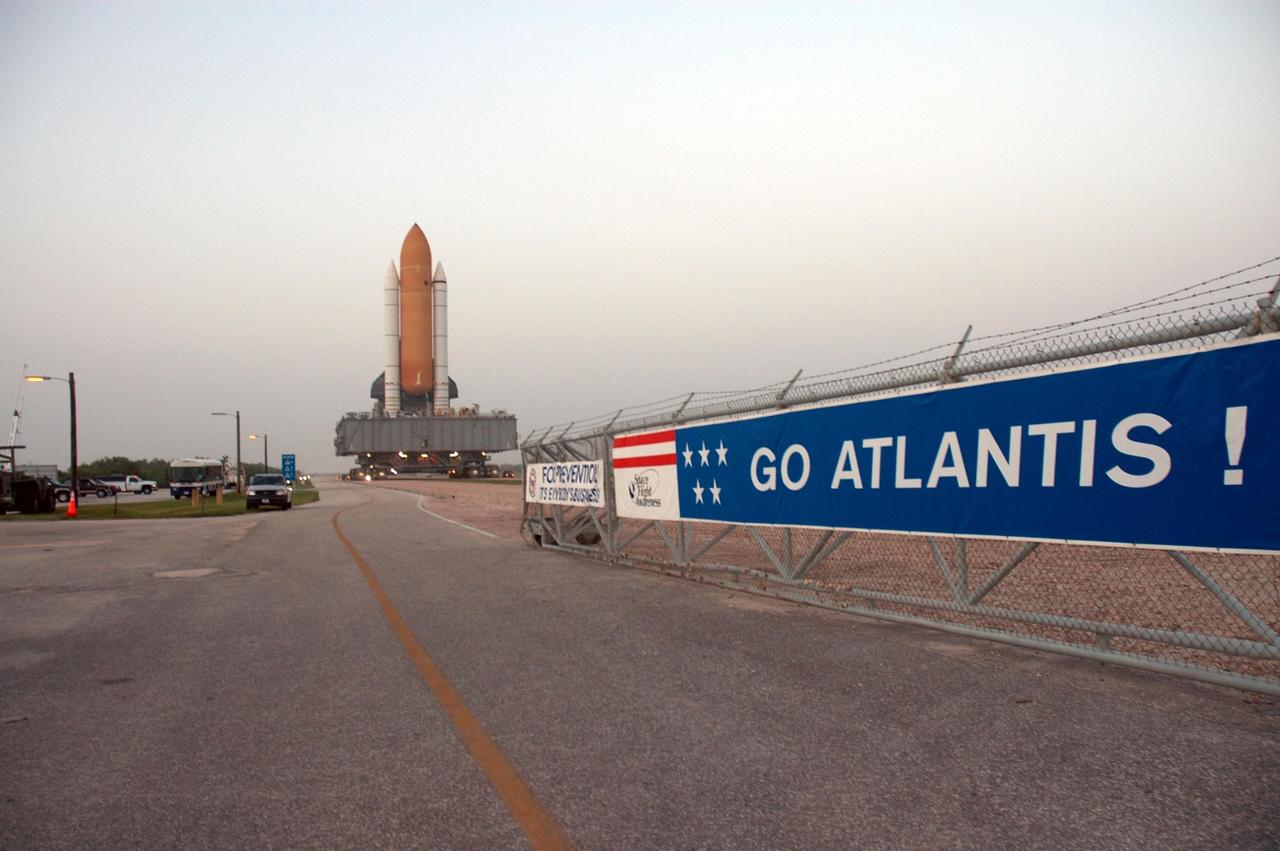 KENNEDY SPACE CENTER, FLA. -   Sitting on top of the mobile launcher platform, Space Shuttle Atlantis rolls out to Launch Pad 39B via the crawlerway.  First motion out of the Vehicle Assembly Building was 1:05 a.m.  The slow speed of the crawler results in a 6-hour trek to the pad approximately 4 miles away.  Atlantis' launch window begins Aug. 27 for an 11-day mission to the International Space Station. The STS-115 crew of six astronauts will continue construction of the station and install their cargo, the Port 3/4 truss segment with its two large solar arrays.   Photo credit: NASA/Troy Cryder