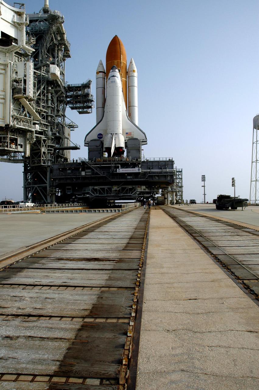 KENNEDY SPACE CENTER, FLA. -   After its overnight rollout from the Vehicle Assembly Building, Space Shuttle Atlantis rests on the hard stand on Launch Pad 39B.   The shuttle sits on top of the mobile launcher platform.  The crawler, which transported it, is still underneath.  The slow speed of the crawler results in a 6-hour trek to the pad approximately 4 miles away.  Atlantis' launch window begins Aug. 27 for an 11-day mission to the International Space Station. The STS-115 crew of six astronauts will continue construction of the station and install their cargo, the Port 3/4 truss segment with its two large solar arrays.   Photo credit: NASA/Troy Cryder