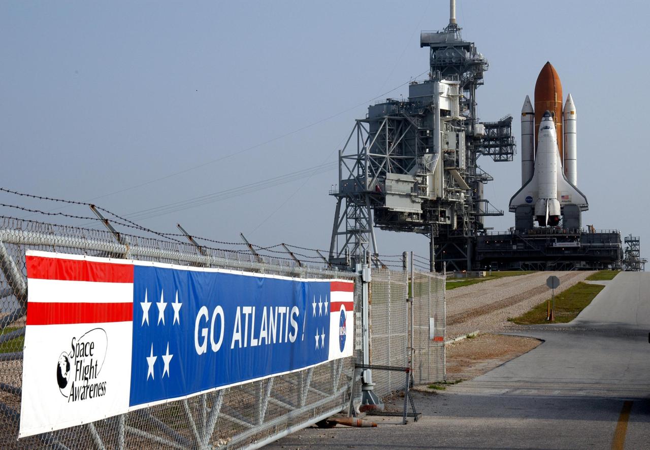KENNEDY SPACE CENTER, FLA. -    Space Shuttle Atlantis sits on the hardstand of Launch Pad 39B after its nearly 8-hour rollout from the Vehicle Assembly Building.  At left of the shuttle are the rotating service structure and fixed service structure. The slow speed of the crawler results in a 6- to 8-hour trek to the pad approximately 4 miles away.  Atlantis' launch window begins Aug. 27 for an 11-day mission to the International Space Station. The STS-115 crew of six astronauts will continue construction of the station and install their cargo, the Port 3/4 truss segment with its two large solar arrays.   Photo credit: NASA/Tony Gray