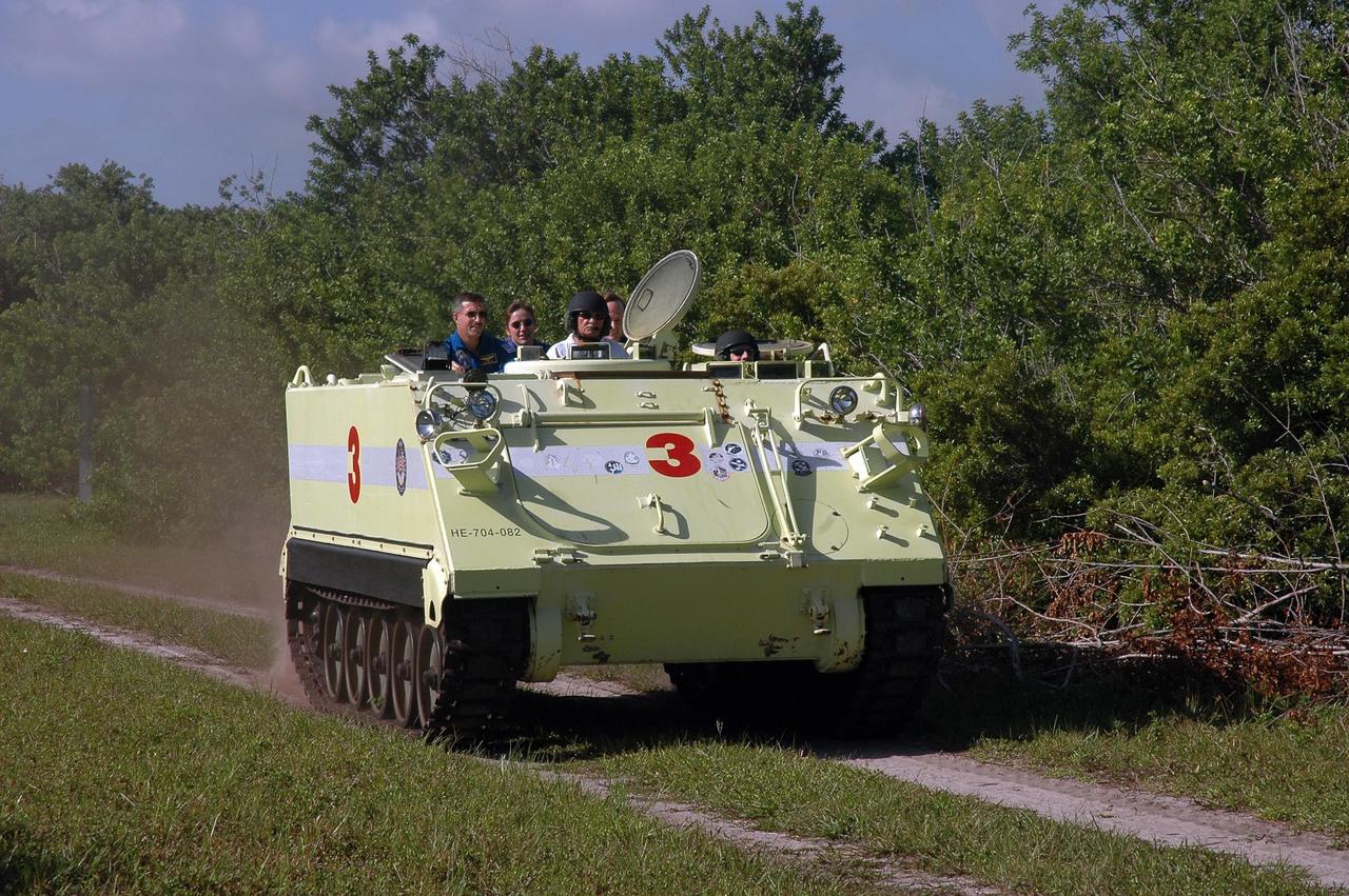 KENNEDY SPACE CENTER, FLA. -  STS-115 Pilot Christopher Ferguson takes the wheel to practice driving the M-113 armored personnel carrier.  Passengers on the carrier are (from left) Mission Specialists Daniel Burbank and Heidemarie Stefanyshyn-Piper, Capt. George Hoggard, who is astronaut rescue team leader, and Mission Specialist Steven MacLean. The STS-115 crew are at NASA's Kennedy Space Center for Terminal Countdown Demonstration Test activities such as the M-113 training.  They will also practice emergency egress from the launch pad and take part in a simulated launch countdown.  Liftoff of mission STS-115 aboard Space Shuttle Atlantis is scheduled in a window beginning Aug. 27.   Photo credit: NASA/Cory Huston