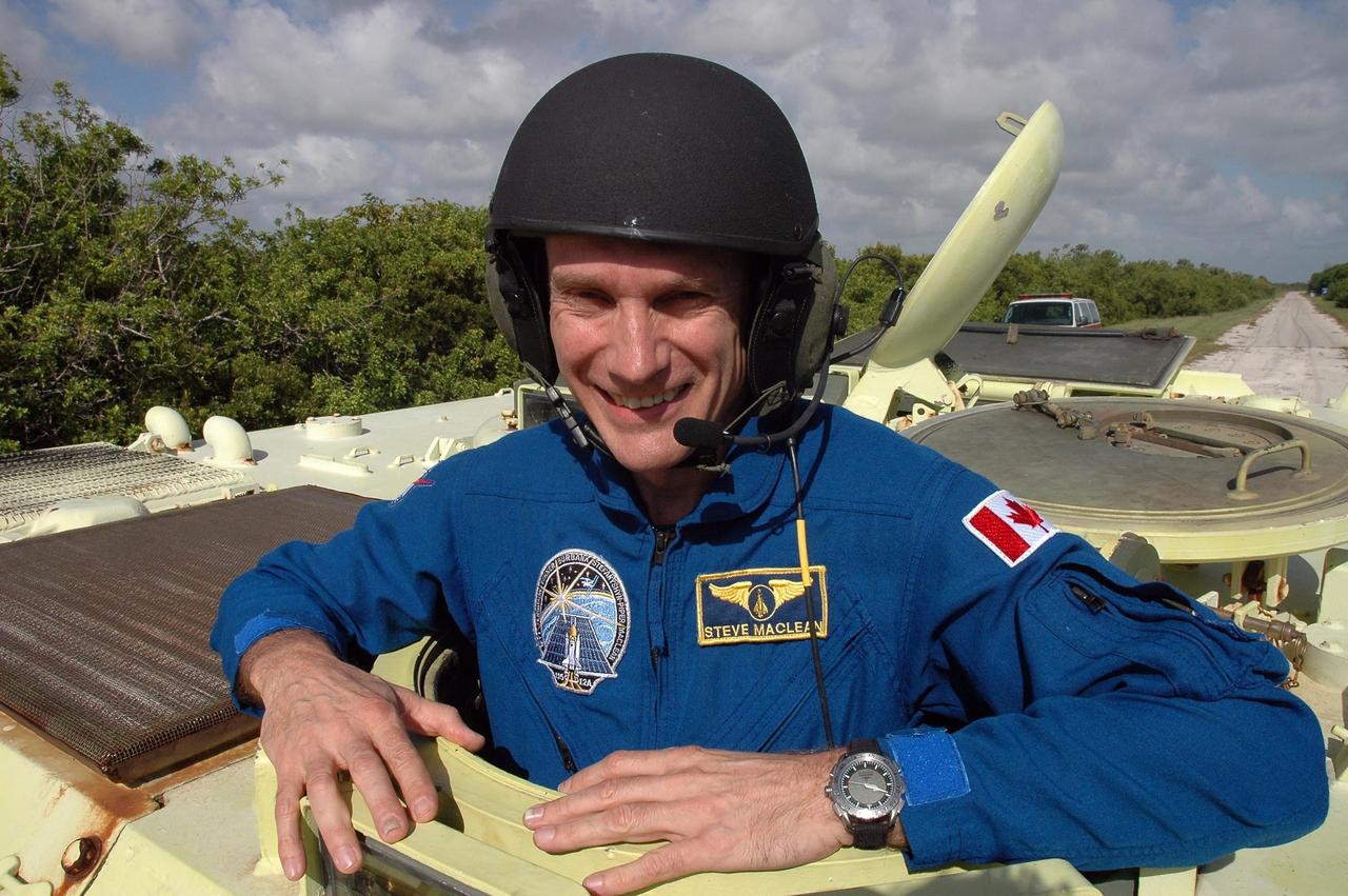 KENNEDY SPACE CENTER, FLA. - STS-115 Mission Specialist Steven MacLean is ready to practice driving the M-113 armored personnel carrier. MacLean represents the Canadian Space Agency. The STS-115 crew are at NASA's Kennedy Space Center for Terminal Countdown Demonstration Test activities such as the M-113 training. They will also practice emergency egress from the launch pad and take part in a simulated launch countdown. Liftoff of mission STS-115 aboard Space Shuttle Atlantis is scheduled in a window beginning Aug. 27. Photo credit: NASA/Cory Huston