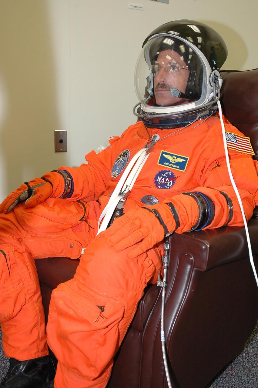 KENNEDY SPACE CENTER, FLA. - The STS-115 crew members are checking the fit of their launch and entry suits before tomorrow's simulated launch countdown. In the chair is Mission Specialist Daniel Burbank. The simulation is the culmination of Terminal Countdown Demonstration Test activities at NASA's Kennedy Space Center. The crew is getting ready for their launch on Space Shuttle Atlantis, scheduled to take place in a window that opens Aug. 27. During the 11-day mission to the International Space Station, the STS-115 crew will continue construction of the station and install their cargo, the Port 3/4 truss segment with its two large solar arrays. Photo credit: NASA/Cory Huston