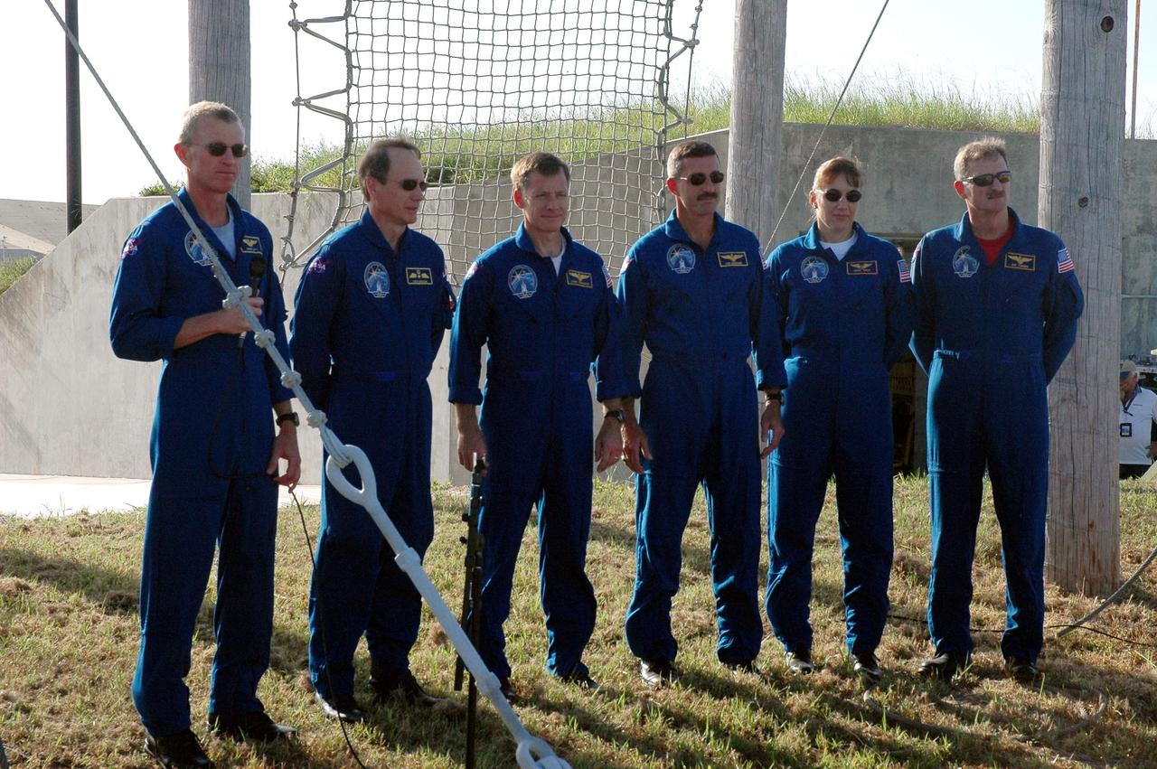 KENNEDY SPACE CENTER, FLA. - The STS-115 crew responds to questions from the media at a press conference on Launch Pad 39B. Seen left to right are Commander Brent Jett, Mission Specialist Steven MacLean, Pilot Chris Ferguson, and Mission Specialists Daniel Burbank, Heidemarie Stefanyshyn-Piper and Joseph Tanner. MacLean is with the Canadian Space Agency. The mission crew is at KSC for Terminal Countdown Demonstration Test activities that are preparation for launch on Space Shuttle Atlantis, scheduled to take place in a window that opens Aug. 27. The TCDT culminates in a simulated launch countdown. During their 11-day mission to the International Space Station, the STS-115 crew will continue construction of the station and attach the payload elements, the Port 3/4 truss segment with its two large solar arrays. Photo credit: NASA/Cory Huston