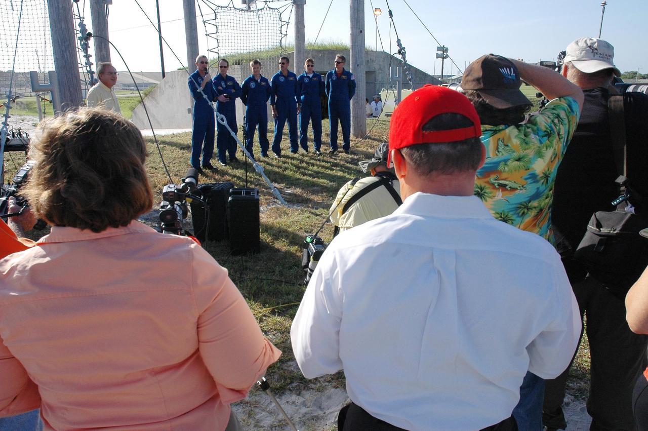 KENNEDY SPACE CENTER, FLA. - The STS-115 crew responds to questions from the media at a press conference held on Launch Pad 39B. Seen left to right are Commander Brent Jett, Mission Specialist Steven MacLean, Pilot Chris Ferguson, and Mission Specialists Daniel Burbank, Heidemarie Stefanyshyn-Piper and Joseph Tanner. MacLean is with the Canadian Space Agency. The mission crew is at KSC for Terminal Countdown Demonstration Test activities that are preparation for launch on Space Shuttle Atlantis, scheduled to take place in a window that opens Aug. 27. The TCDT culminates in a simulated launch countdown. During their 11-day mission to the International Space Station, the STS-115 crew will continue construction of the station and attach the payload elements, the Port 3/4 truss segment with its two large solar arrays. Photo credit: NASA/Cory Huston