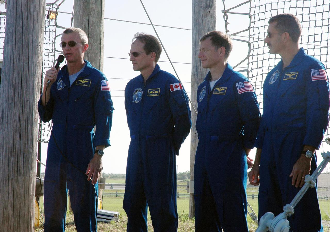 KENNEDY SPACE CENTER, FLA. - The STS-115 crew responds to questions from the media at a press conference held on Launch Pad 39B. Seen left to right are Commander Brent Jett, Mission Specialist Steven MacLean, Pilot Chris Ferguson, and Mission Specialist Daniel Burbank. Crew members not seen are Mission Specialists Heidemarie Stefanyshyn-Piper and Joseph Tanner. MacLean is with the Canadian Space Agency. The mission crew is at KSC for Terminal Countdown Demonstration Test activities that are preparation for launch on Space Shuttle Atlantis, scheduled to take place in a window that opens Aug. 27. The TCDT culminates in a simulated launch countdown. During their 11-day mission to the International Space Station, the STS-115 crew will continue construction of the station and attach the payload elements, the Port 3/4 truss segment with its two large solar arrays. Photo credit: NASA/Cory Huston
