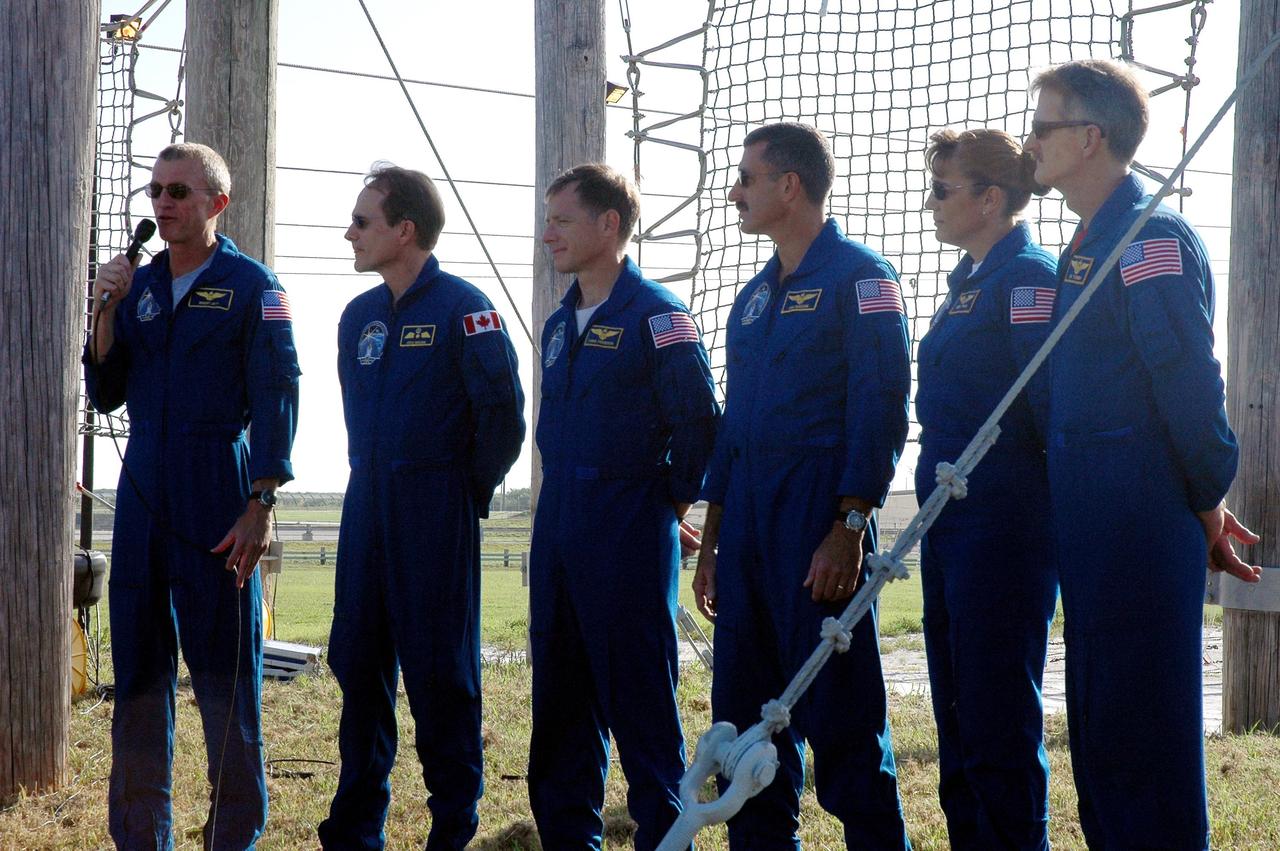 KENNEDY SPACE CENTER, FLA. - The STS-115 crew responds to questions from the media at a press conference held on Launch Pad 39B. Seen left to right are Commander Brent Jett, Mission Specialist Steven MacLean, Pilot Chris Ferguson, and Mission Specialists Daniel Burbank, Heidemarie Stefanyshyn-Piper and Joseph Tanner. MacLean is with the Canadian Space Agency. The mission crew is at KSC for Terminal Countdown Demonstration Test activities that are preparation for launch on Space Shuttle Atlantis, scheduled to take place in a window that opens Aug. 27. The TCDT culminates in a simulated launch countdown. During their 11-day mission to the International Space Station, the STS-115 crew will continue construction of the station and attach the payload elements, the Port 3/4 truss segment with its two large solar arrays. Photo credit: NASA/Cory Huston