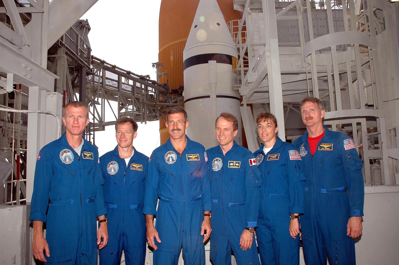 KENNEDY SPACE CENTER, FLA. - The STS-115 crew pauses for a photo during training on Launch Pad 39B. From left are Mission Commander Brent Jett, Pilot Chris Ferguson, and Mission Specialists Daniel Burbank, Steven MacLean, Heidemarie Stefanyshyn-Piper and Joseph Tanner. The mission crew is at KSC for Terminal Countdown Demonstration Test (TCDT) activities that are preparation for launch on Space Shuttle Atlantis, scheduled to take place in a window that opens Aug. 27. During their 11-day mission to the International Space Station, the STS-115 crew will continue construction of the station and attach the payload elements, the Port 3/4 truss segment with its two large solar arrays. Photo credit: NASA/Cory Huston