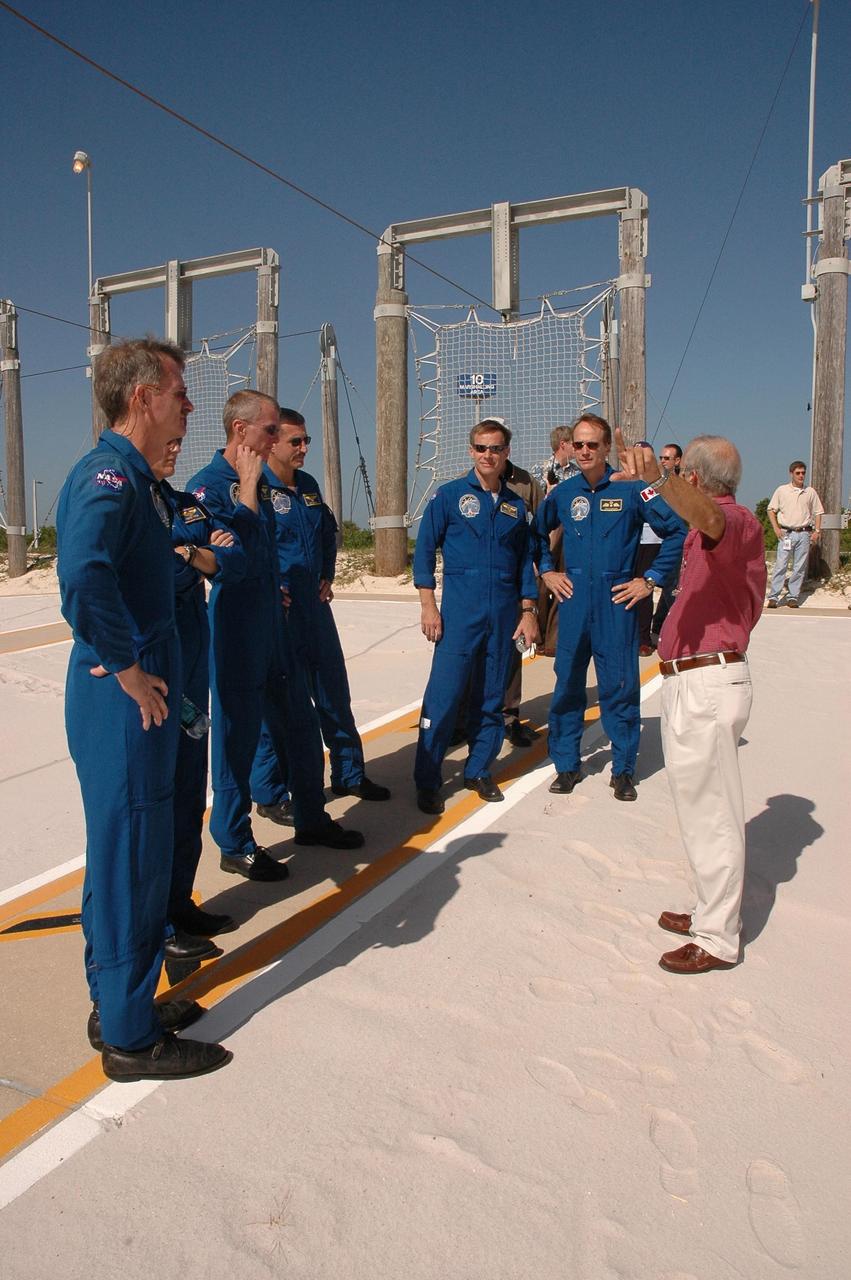 KENNEDY SPACE CENTER, FLA. - The STS-115 crew gets instructions on landing the slidewire baskets, used during emergency egress from the launch pad. From left are Mission Specialists Joseph Tanner and Heidemarie Stefanyshyn-Piper, Commander Brent Jett, and Mission Specialists Daniel Burbank, Chris Ferguson and Steven MacLean, who is with the Canadian Space Agency. The mission crew is at KSC for Terminal Countdown Demonstration Test (TCDT) activities that are preparation for launch on Space Shuttle Atlantis, scheduled to take place in a window that opens Aug. 27. During their 11-day mission to the International Space Station, the STS-115 crew will continue construction of the station and attach the payload elements, the Port 3/4 truss segment with its two large solar arrays. Photo credit: NASA/Cory Huston