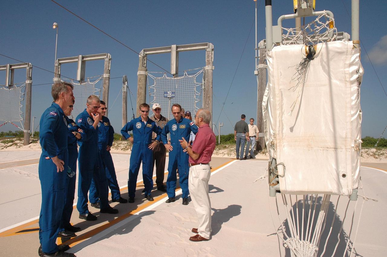 KENNEDY SPACE CENTER, FLA. - The STS-115 crew gets instructions on landing the slidewire baskets, used during emergency egress from the launch pad. From left are Mission Specialists Joseph Tanner and Heidemarie Stefanyshyn-Piper, Commander Brent Jett, and Mission Specialists Daniel Burbank, Chris Ferguson and Steven MacLean, who is with the Canadian Space Agency. The mission crew is at KSC for Terminal Countdown Demonstration Test (TCDT) activities that are preparation for launch on Space Shuttle Atlantis, scheduled to take place in a window that opens Aug. 27. During their 11-day mission to the International Space Station, the STS-115 crew will continue construction of the station and attach the payload elements, the Port 3/4 truss segment with its two large solar arrays. Photo credit: NASA/Cory Huston