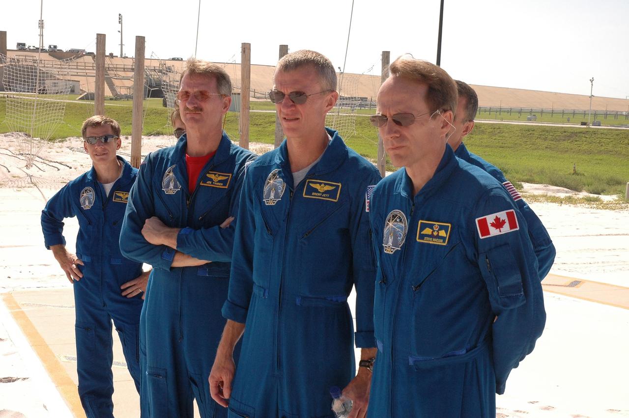 KENNEDY SPACE CENTER, FLA. - The STS-115 crew gets instructions on landing the slidewire baskets, used during emergency egress from the launch pad. Visible from left are Pilot Chris Ferguson, Mission Specialist Joseph Tanner, Commander Brent Jett, Mission Specialist Steven MacLean, who is with the Canadian Space Agency. Partially hidden behind them are Mission Specialists Heidemarie Stefanyshyn-Piper and Daniel Burbank. The mission crew is at KSC for Terminal Countdown Demonstration Test (TCDT) activities that are preparation for launch on Space Shuttle Atlantis, scheduled to take place in a window that opens Aug. 27. During their 11-day mission to the International Space Station, the STS-115 crew will continue construction of the station and attach the payload elements, the Port 3/4 truss segment with its two large solar arrays. Photo credit: NASA/Cory Huston