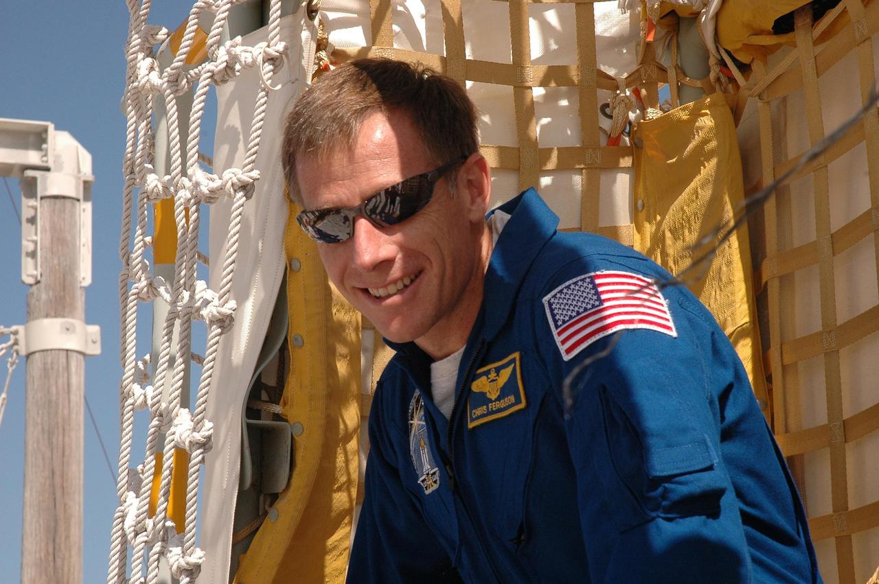 KENNEDY SPACE CENTER, FLA. - The STS-115 crew practices exiting from the slidewire basket, used during emergency egress from the launch pad. Sitting in the basket is Pilot Chris Ferguson. The mission crew is at KSC for Terminal Countdown Demonstration Test (TCDT) activities that are preparation for launch on Space Shuttle Atlantis, scheduled to take place in a window that opens Aug. 27. During their 11-day mission to the International Space Station, the STS-115 crew will continue construction of the station and attach the payload elements, the Port 3/4 truss segment with its two large solar arrays. Photo credit: NASA/Cory Huston