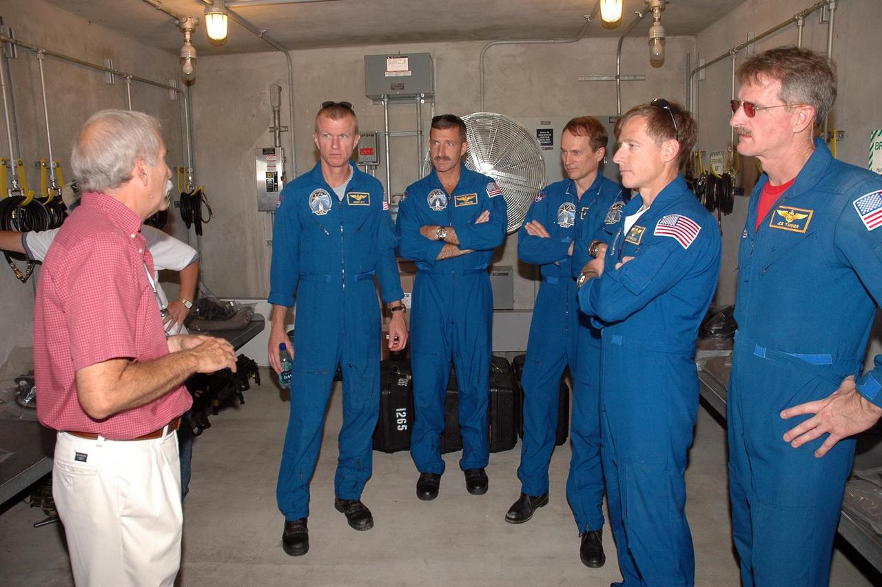 KENNEDY SPACE CENTER, FLA. - The STS-115 crew learn about use of the bunker in the event of an emergency at the launch pad. Seen in the photo are, from left, Commander Brent Jett, Mission Specialists Daniel Burbank and Steven MacLean, Pilot Chris Ferguson and Mission Specialist Joseph Tanner. Not pictured is Mission Specialist Heidemarie Stefanyshyn-Piper. The mission crew is at KSC for Terminal Countdown Demonstration Test (TCDT) activities that are preparation for launch on Space Shuttle Atlantis, scheduled to take place in a window that opens Aug. 27. During their 11-day mission to the International Space Station, the STS-115 crew will continue construction of the station and attach the payload elements, the Port 3/4 truss segment with its two large solar arrays. Photo credit: NASA/Cory Huston
