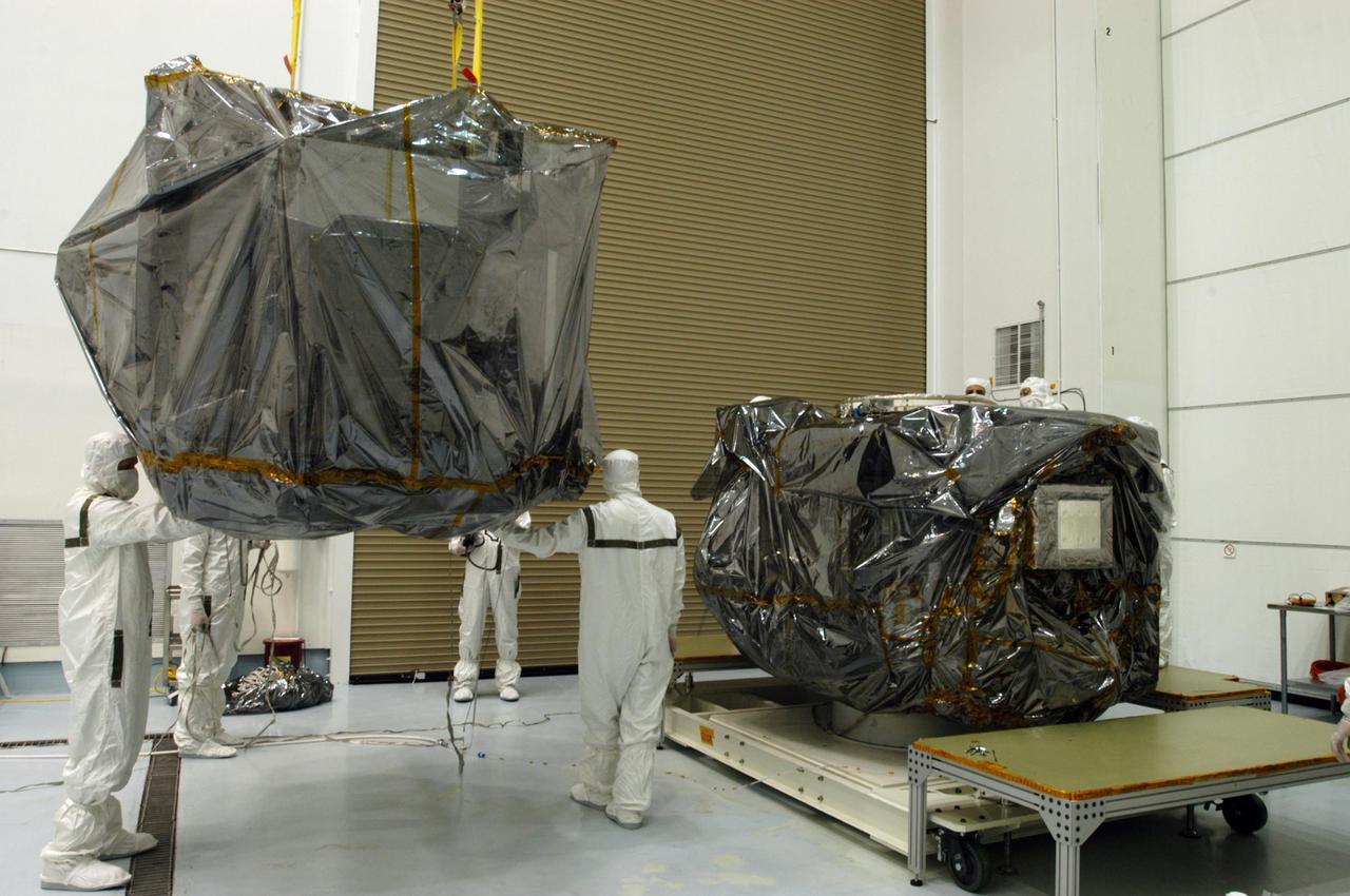 KENNEDY SPACE CENTER, FLA. - At Astrotech Space Operations in Titusville, Fla., one of the STEREO observatories is lifted and moved toward the other observatory, in the background. They will be mated for launch. STEREO, which stands for Solar Terrestrial Relations Observatory, is the first to take measurements of the sun and solar wind in 3-dimension. This new view will improve our understanding of space weather and its impact on the Earth. STEREO is expected to lift off aboard a Boeing Delta II rocket from Launch Pad 17-B at Cape Canaveral Air Force Station on Aug. 31. Photo credit: NASA/George Shelton
