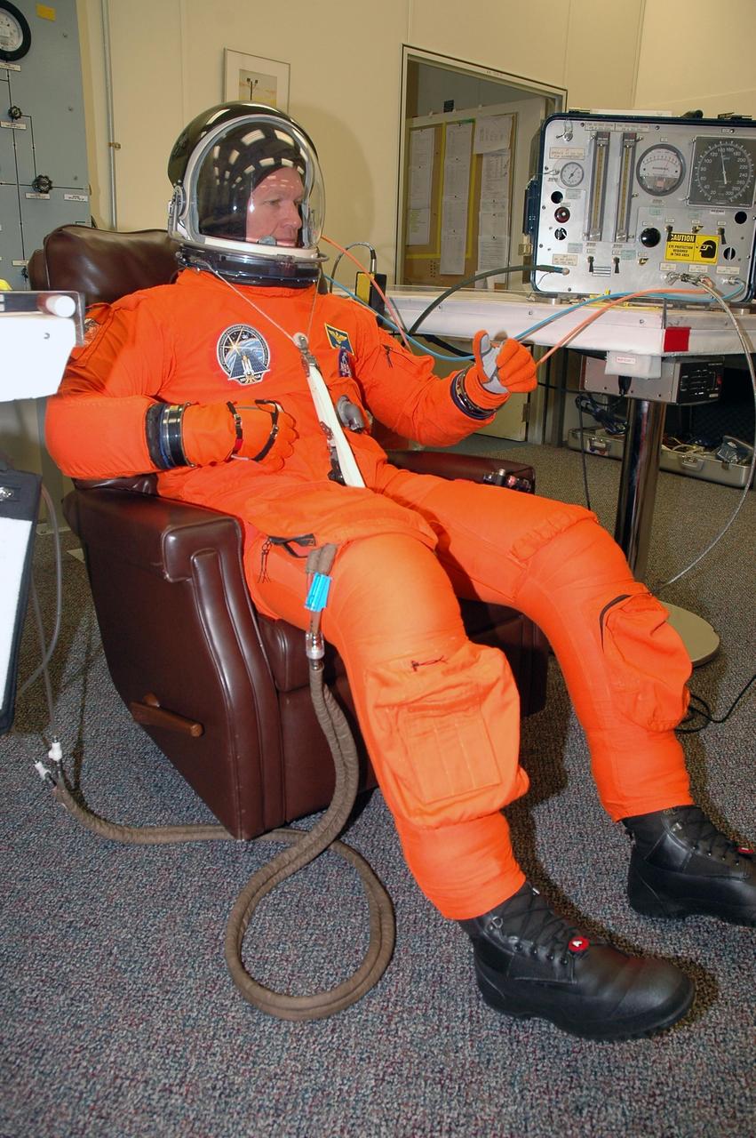KENNEDY SPACE CENTER, FLA. - The STS-115 crew members are suiting up for their simulated launch countdown. Shown here is Commander Brent Jett. The mission crew is at KSC for Terminal Countdown Demonstration Test (TCDT) activities that are preparation for launch on Space Shuttle Atlantis, scheduled to take place in a window that opens Aug. 27. The TCDT has included emergency egress training as well as the simulation. During their 11-day mission to the International Space Station, the STS-115 crew will continue construction of the station and attach the payload elements, the Port 3/4 truss segment with its two large solar arrays. Photo credit: NASA/Cory Huston