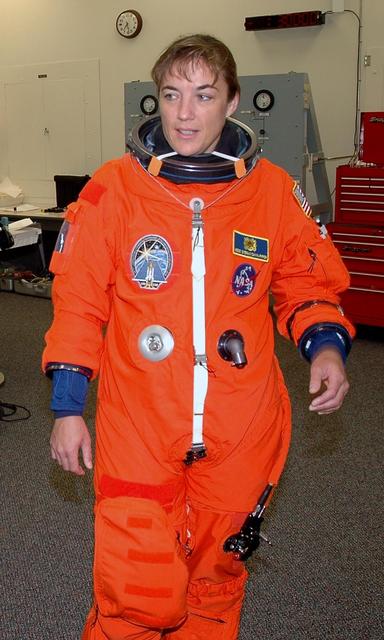 KENNEDY SPACE CENTER, FLA. - The STS-115 crew members are suiting up for their simulated launch countdown. Shown here is Mission Specialist Heidemarie Stefanyshyn-Piper. The mission crew is at KSC for Terminal Countdown Demonstration Test (TCDT) activities that are preparation for launch on Space Shuttle Atlantis, scheduled to take place in a window that opens Aug. 27. The TCDT has included emergency egress training as well as the simulation. During their 11-day mission to the International Space Station, the STS-115 crew will continue construction of the station and attach the payload elements, the Port 3/4 truss segment with its two large solar arrays. Photo credit: NASA/Cory Huston