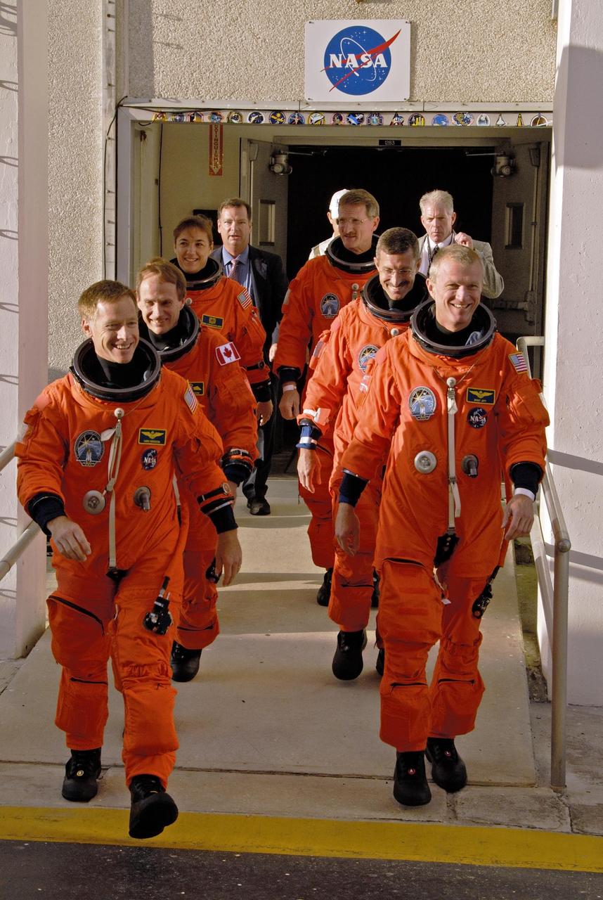 KENNEDY SPACE CENTER, FLA. - The STS-115 crew walks out of the Operations and Checkout Building to head for Launch Pad 39B. Leading the way on the left is Pilot Christopher Ferguson; behind him are Mission Specialists Steven MacLean and Heidemarie Stefanyshyn-Piper. Leading on the right is Commander Brent Jett; behind him re Mission Specialists Daniel Burbank and Joseph Tanner. MacLean is with the Canadian Space Agency. They are taking part in a simulated launch countdown as part of the preparation for the liftoff of Space Shuttle Atlantis on mission STS-115, scheduled to take place in a window that opens Aug. 27. The mission crew has been at KSC for Terminal Countdown Demonstration Test (TCDT) activities, which include emergency egress training and the simulation. During their 11-day mission to the International Space Station, the crew will continue construction of the station and attach the payload elements, the Port 3/4 truss segment with its two large solar arrays. Photo courtesy of Scott Andrews/Nikon