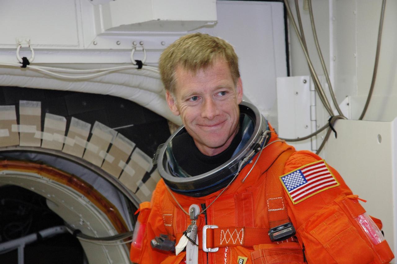 KENNEDY SPACE CENTER, FLA. -  The STS-115 crew members complete their suitup in the White Room before entering Space Shuttle Atlantis on Launch Pad 39B for a simulated launch countdown.  Shown here is Pilot Christopher Ferguson. The White Room, which is located at the end of the orbiter access arm, allows entry into the orbiter through the crew access hatch.  The mission crew is at KSC for Terminal Countdown Demonstration Test (TCDT) activities that are preparation for launch.  Liftoff of Atlantis is scheduled to take place in a window that opens Aug. 27.  During their 11-day mission to the International Space Station, the STS-115 crew will continue construction of the station and attach the payload elements, the Port 3/4 truss segment with its two large solar arrays.  Photo credit: NASA/Jim Grossmann