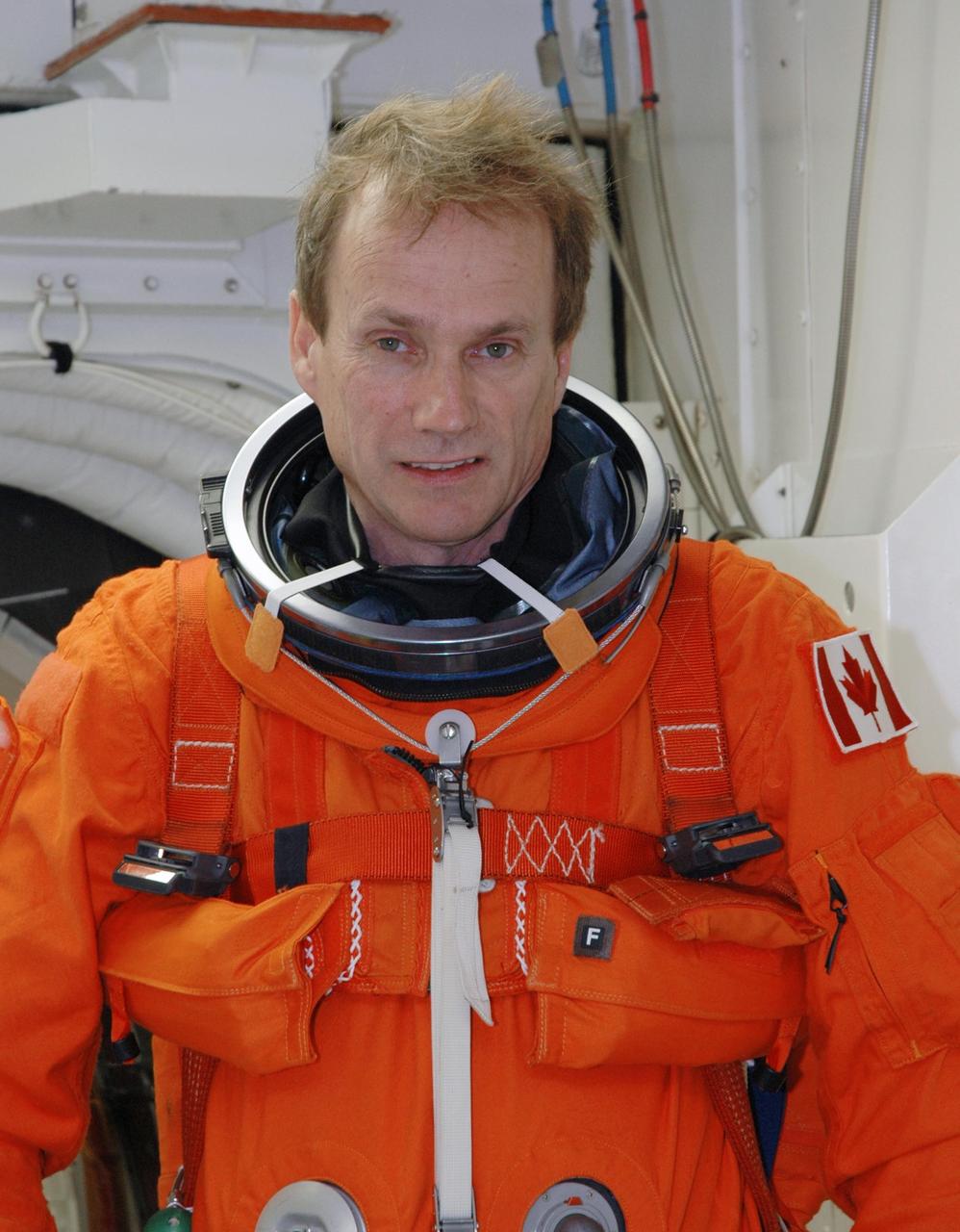 KENNEDY SPACE CENTER, FLA. -  The STS-115 crew members complete their suitup in the White Room before entering Space Shuttle Atlantis on Launch Pad 39B for a simulated launch countdown.  Shown here is Mission Specialist Steven MacLean. The White Room, which is located at the end of the orbiter access arm, allows entry into the orbiter through the crew access hatch.  The mission crew is at KSC for Terminal Countdown Demonstration Test (TCDT) activities that are preparation for launch.  Liftoff of Atlantis is scheduled to take place in a window that opens Aug. 27.  During their 11-day mission to the International Space Station, the STS-115 crew will continue construction of the station and attach the payload elements, the Port 3/4 truss segment with its two large solar arrays.  Photo credit: NASA/Jim Grossmann